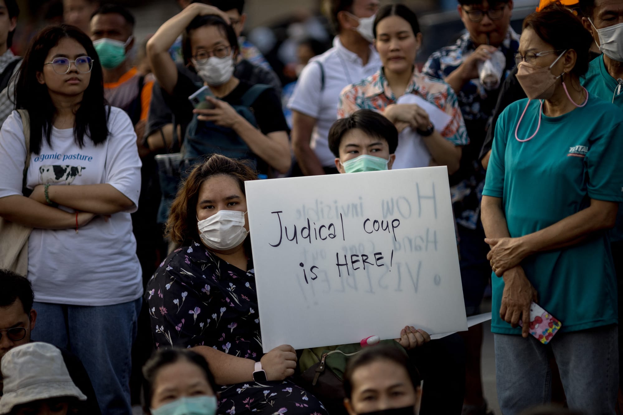 thailand protesters holding sign