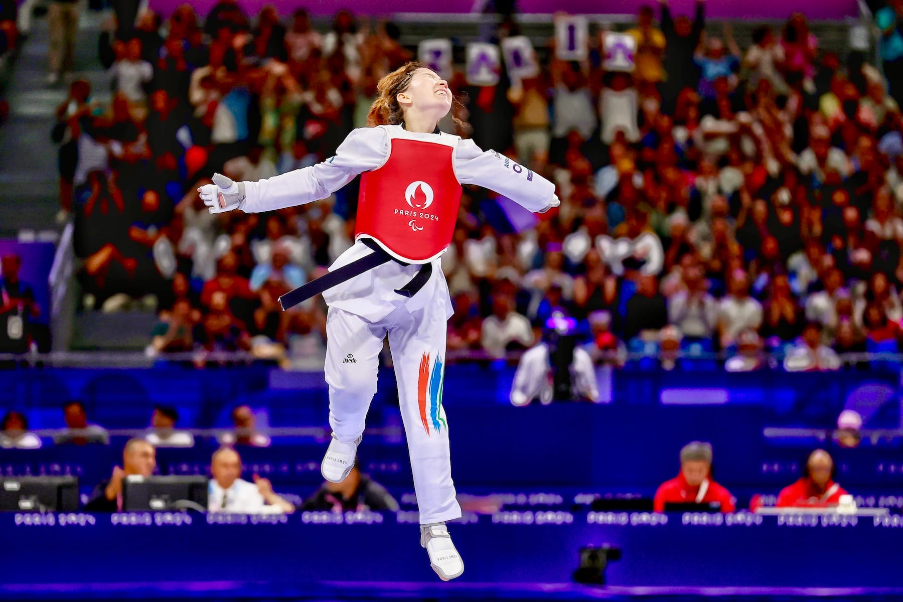 Zakia Khudadadi of Refugee Paralympic Team celebrates after winning the Women's Taekwondo