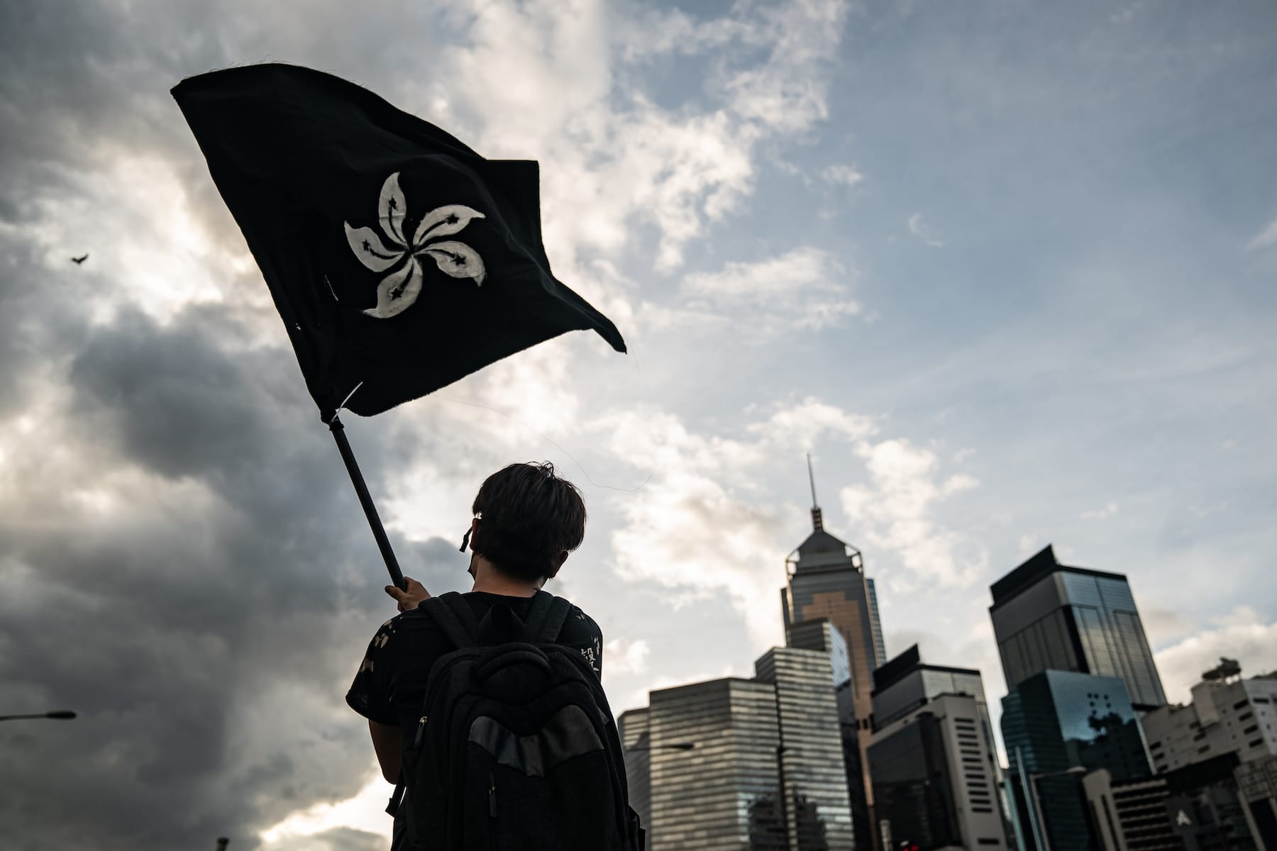 hong kong protester waves black flag