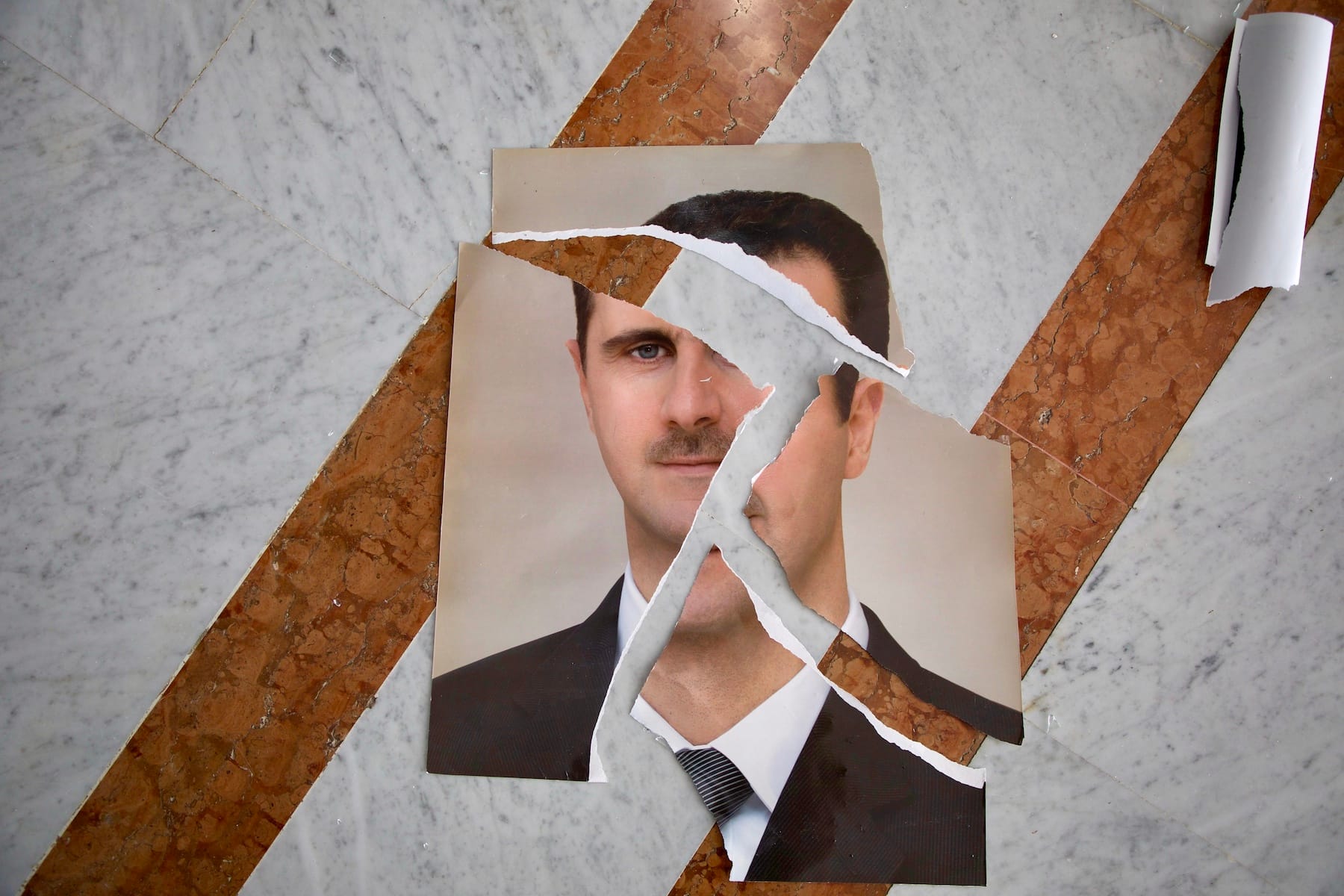 Ripped photo of former Syrian president, Bashar al-Assad