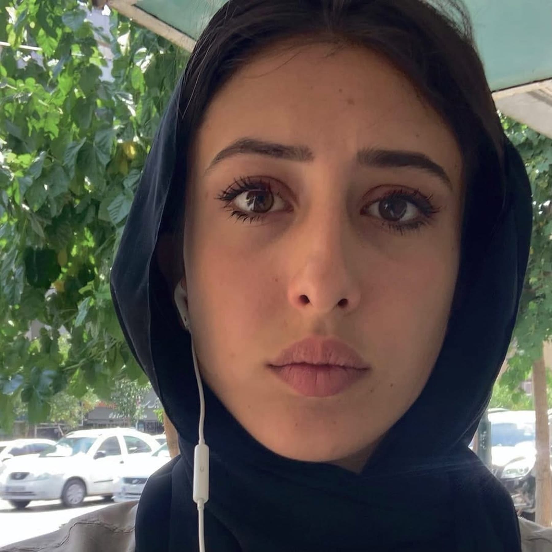 A photo of Cecilia Sala wearing earphones and hijab during her visit to Iran, obtained from X.