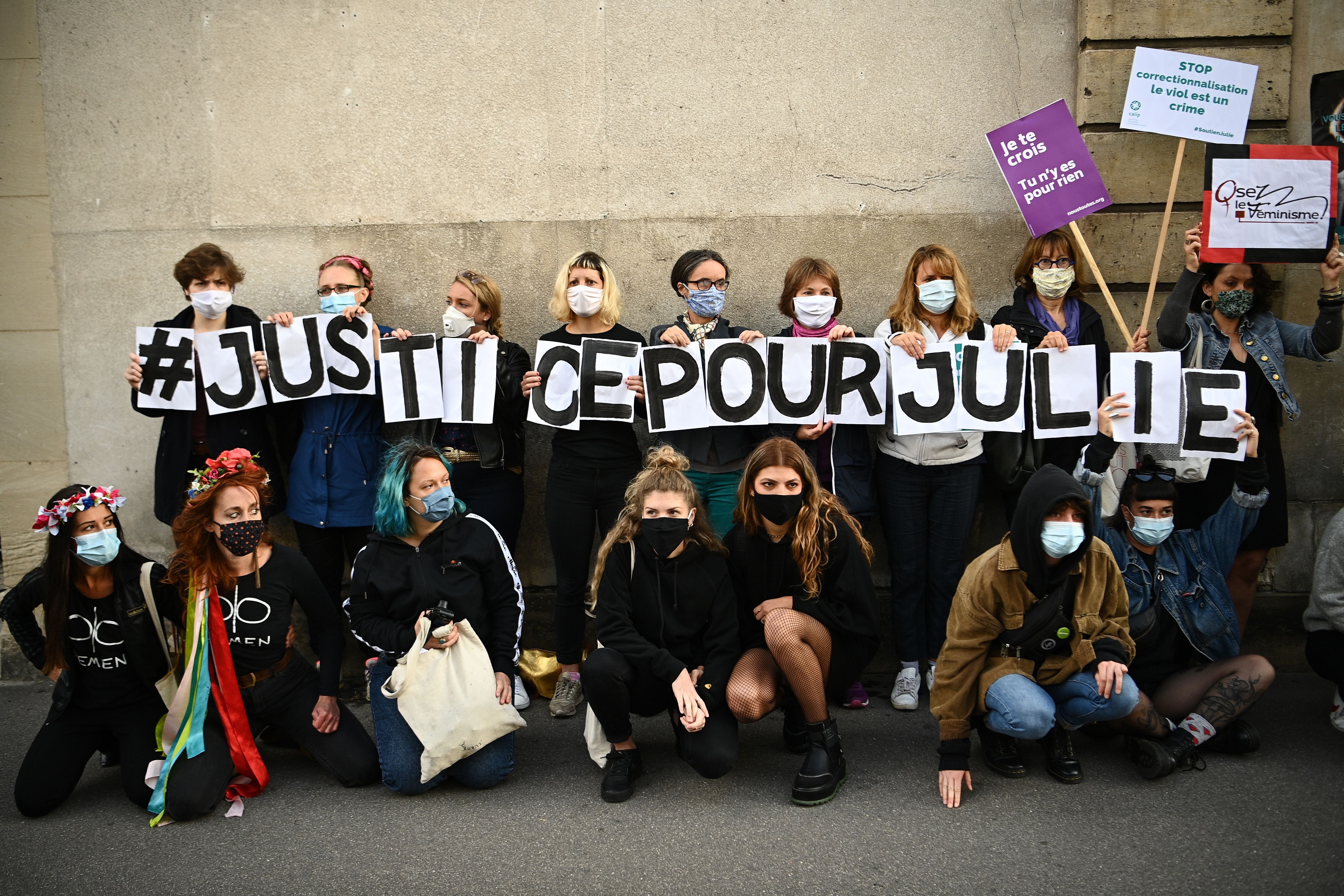 Femen activists, members of women's rights association and member of the "Collages Feminicides Paris" feminist organisation's Marguerite Stern (3L down) hold letters forming the message "Justice for Julie" outside the appeal chamber at Versailles photo.