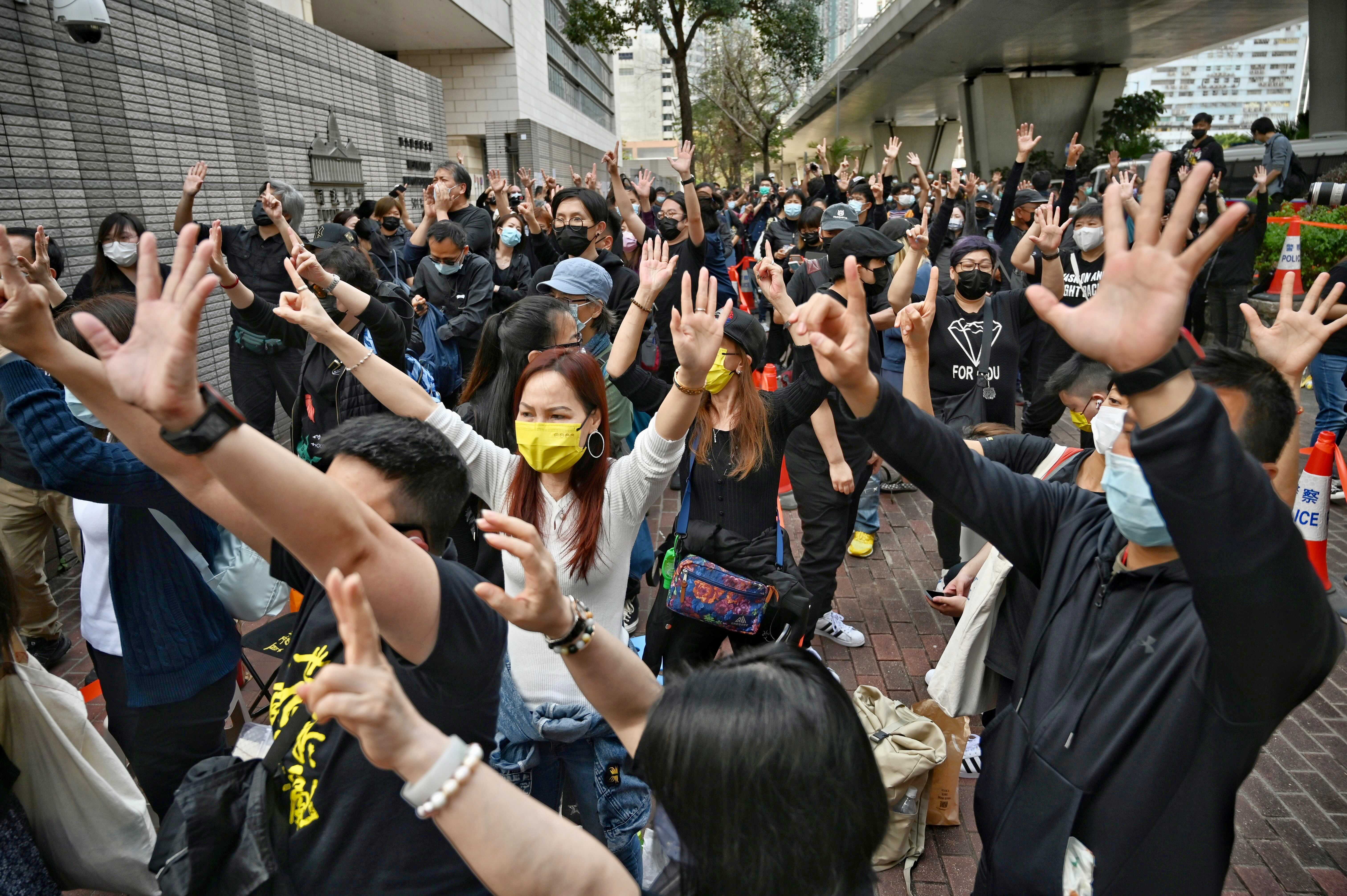 Protesters gather outside court in Hong Kong following 47 activists charged for conspiring to commit sedition.