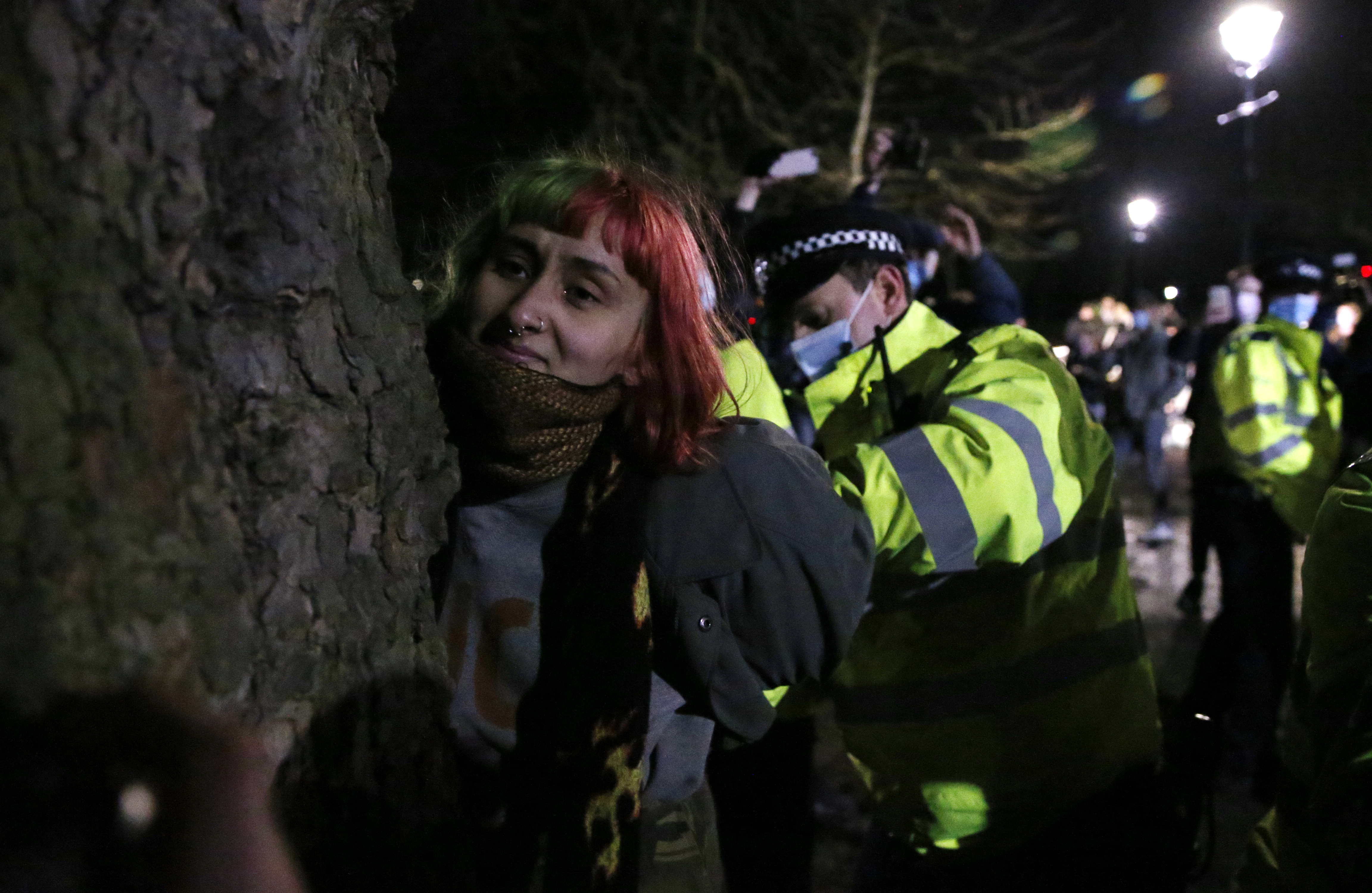 A woman is arrested during a vigil for Sarah Everard on Clapham Common photo.