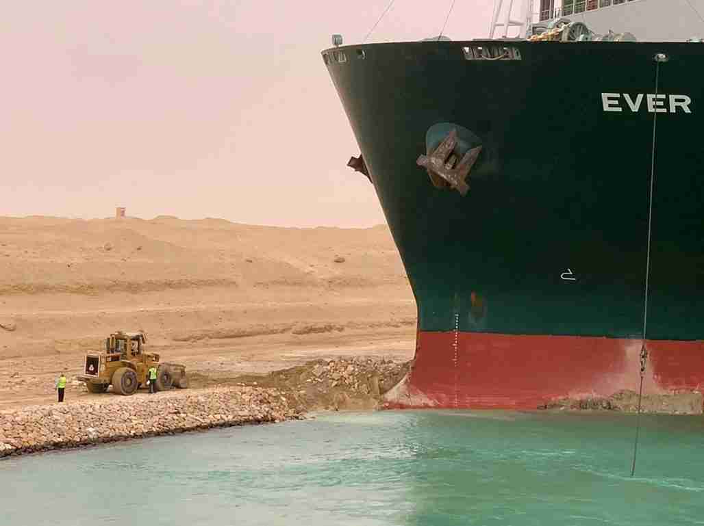 A handout picture released by the Suez Canal Authority shows a part of the Taiwan-owned MV Ever Given lodged sideways and impeding all traffic across the waterway of Egypt's Suez Canal photo.