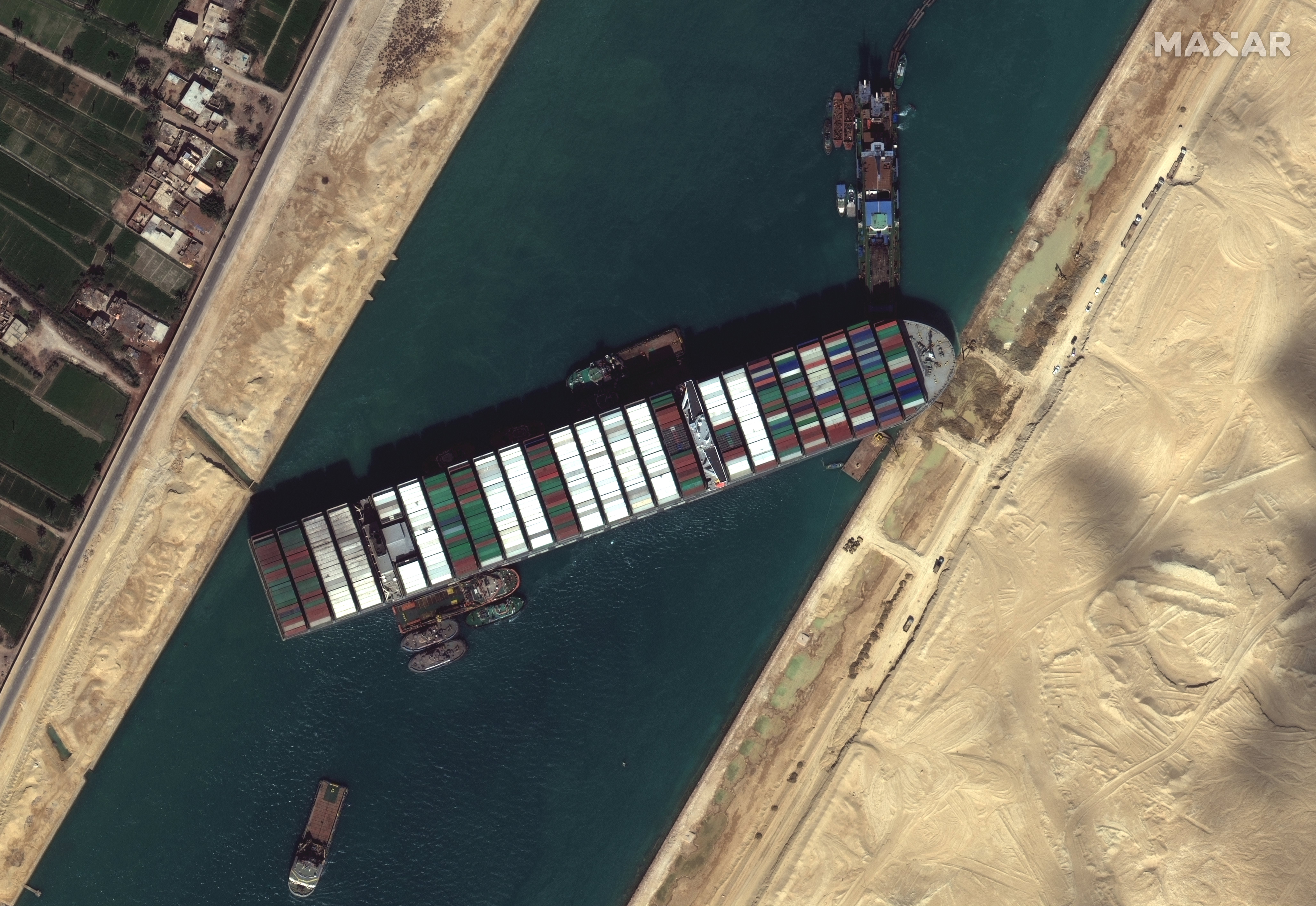 Maxar's WorldView-3 collected new high-resolution satellite imagery of the Suez canal and the container ship (EVER GIVEN) that remains stuck in the canal north of the city of Suez, Egypt photo.