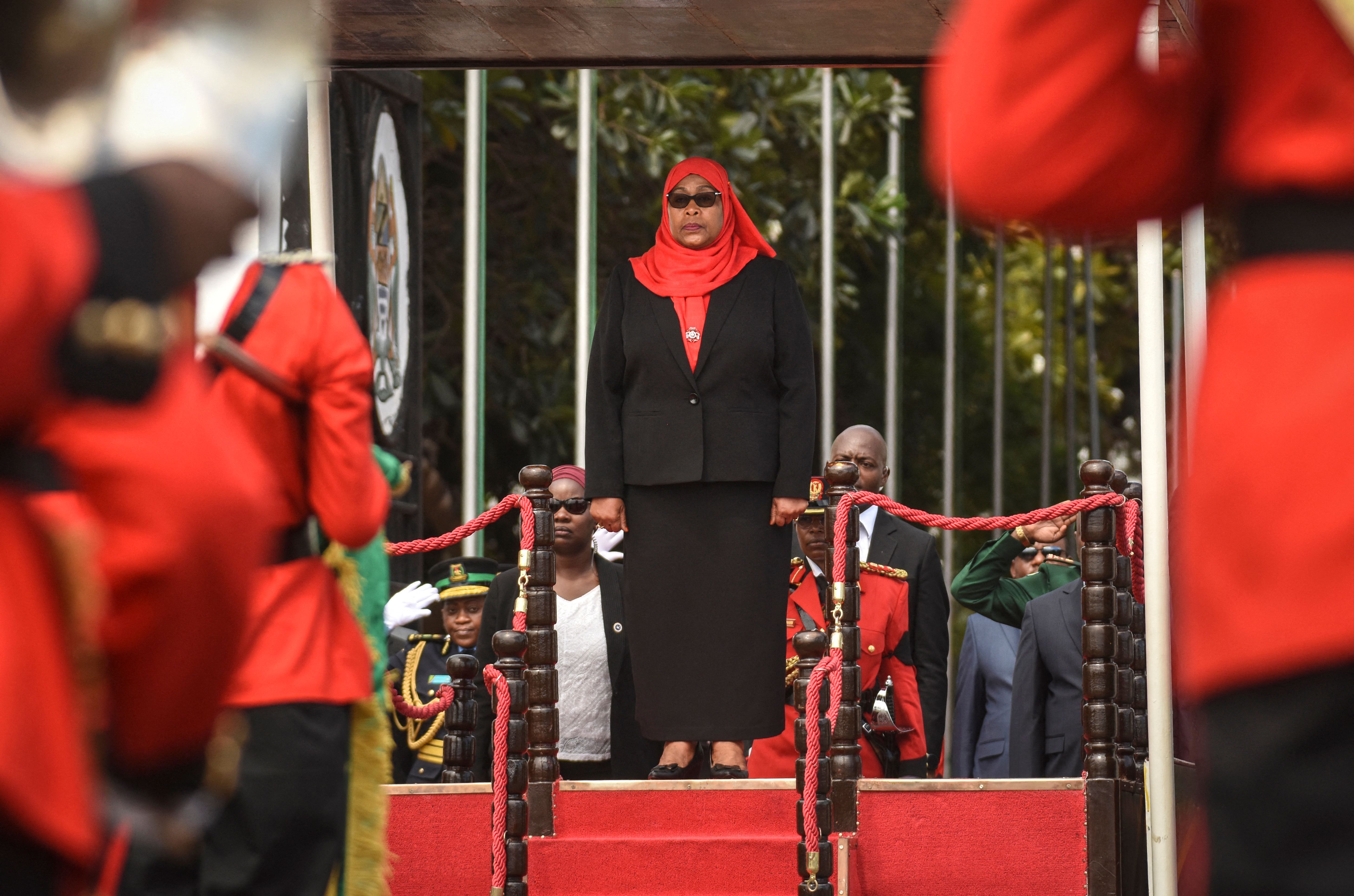 Samia Suluhu Hassan stands during a military parade after swearing-in ceremony as the country's first female President photo. 