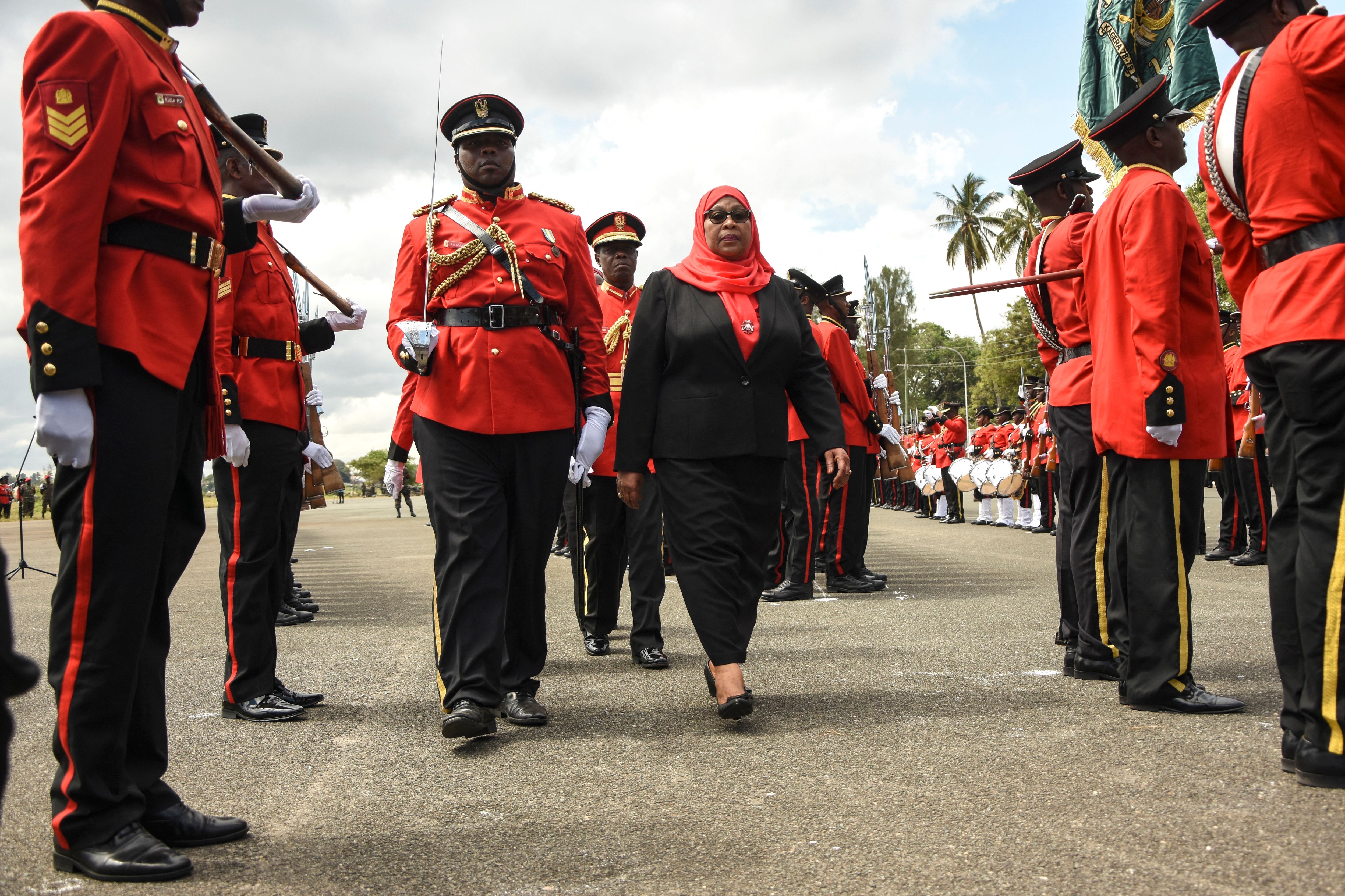 Samia Suluhu Hassan inspects a military honor guard after swearing-in ceremony as the country's first female President photo.