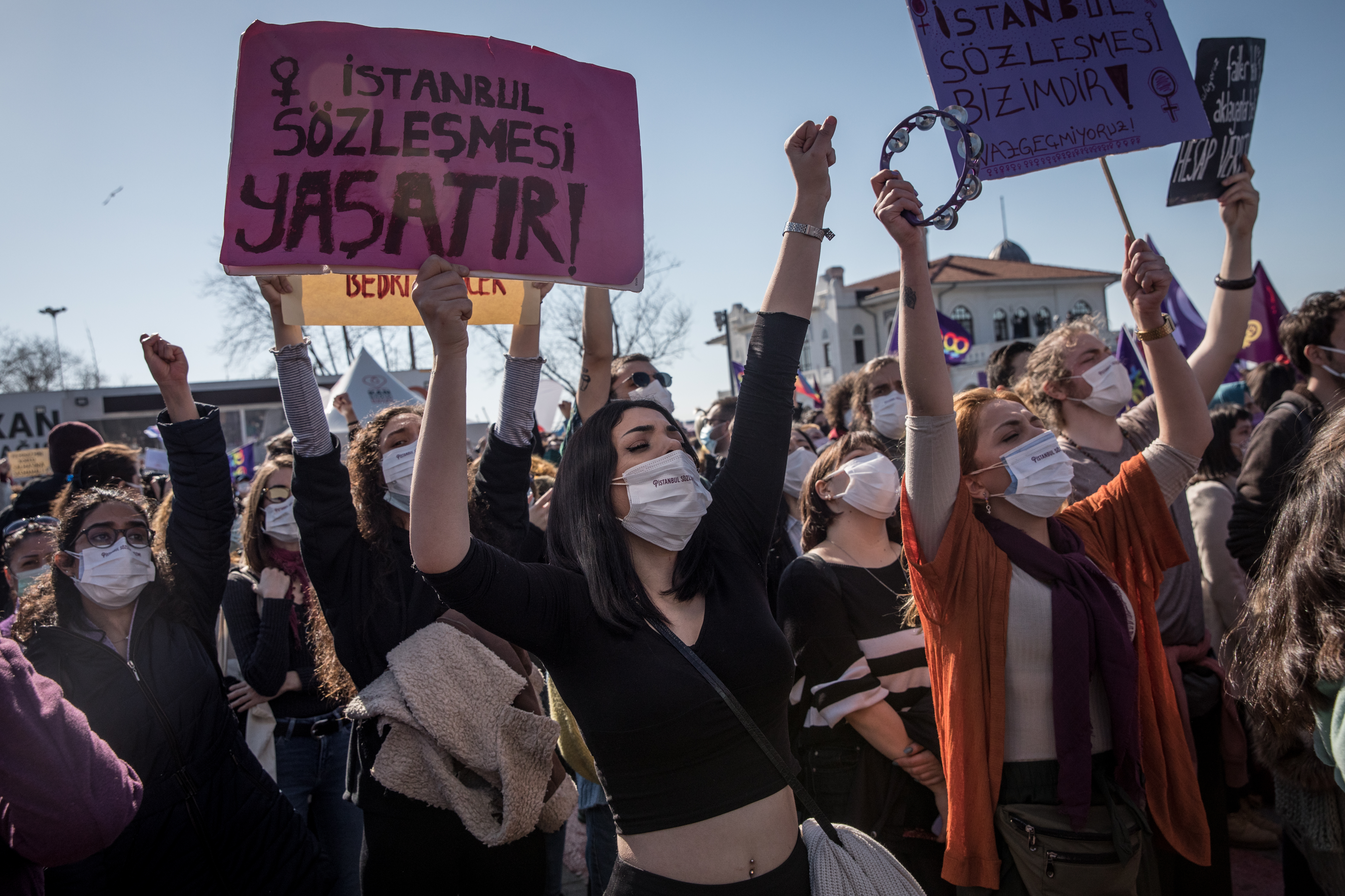 People hold signs and chant slogans during a protest against Turkey's decision to withdraw from the Istanbul Convention in Istanbul, Turkey photo.
