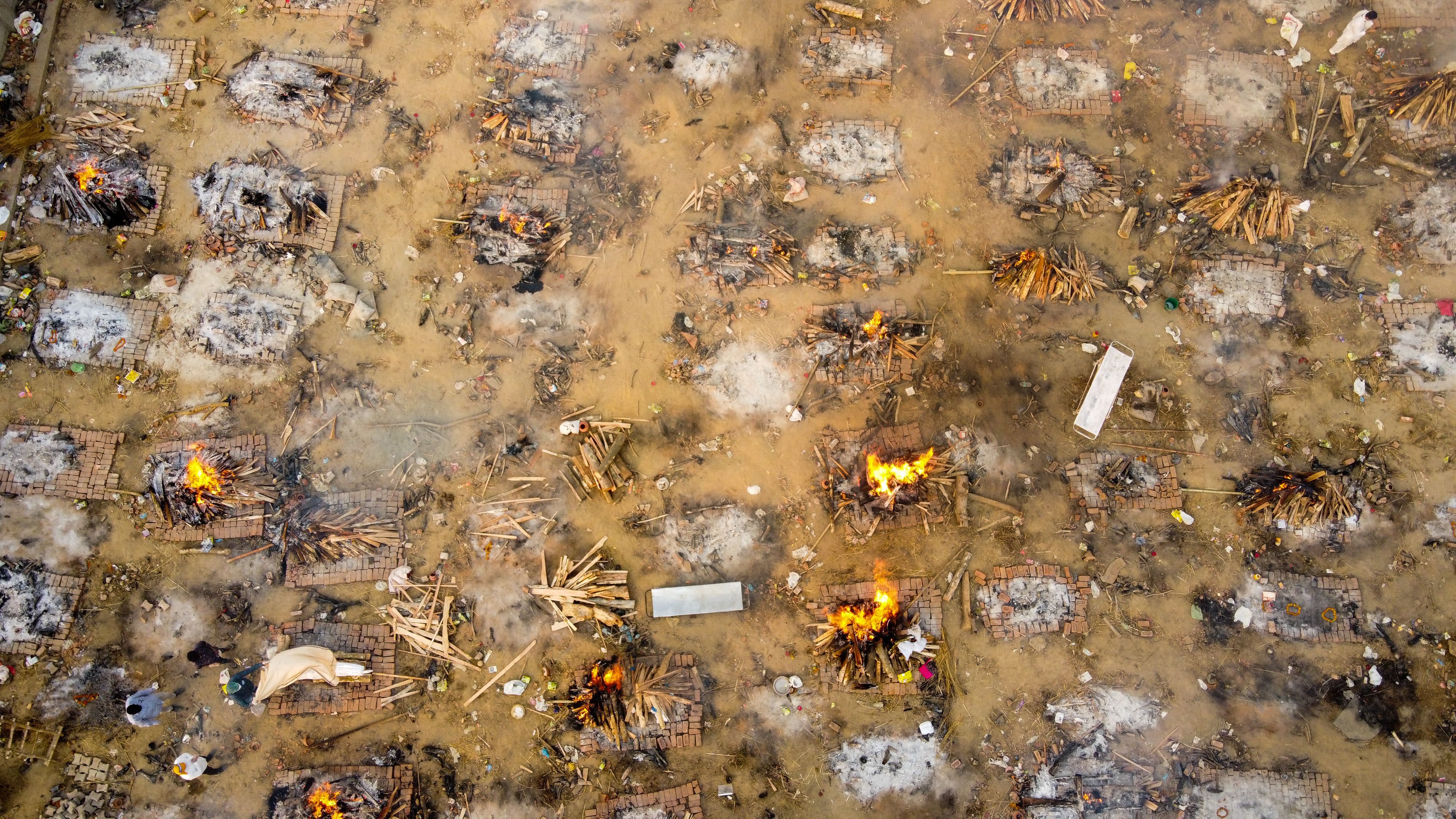 In this aerial picture taken on April 26, 2021, burning pyres of victims who lost their lives due to the Covid-19 coronavirus are seen at a cremation ground in New Delhi.