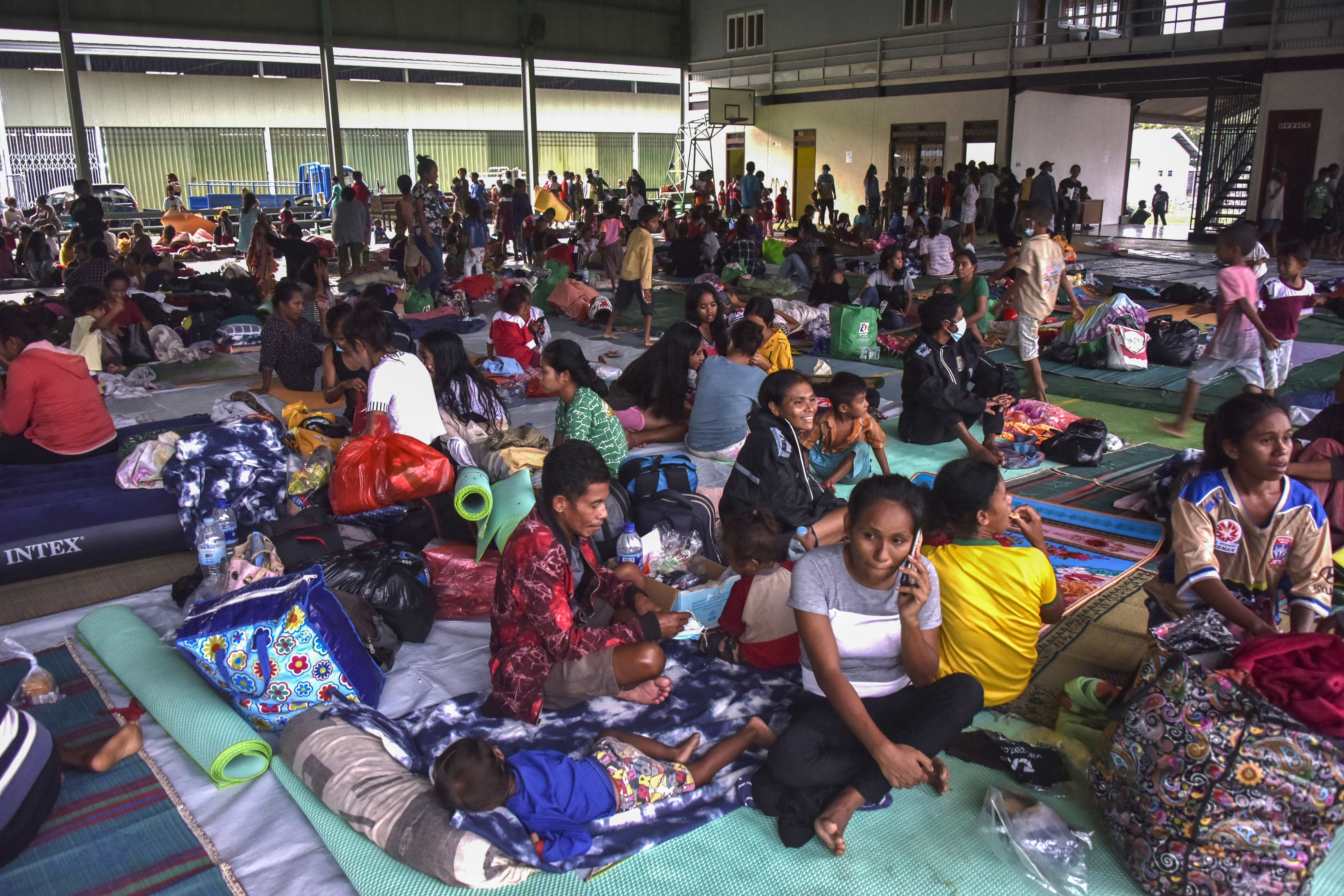 Residents take refuge at an evacuation centre after fleeing their damaged homes in Dili after torrential rains triggered floods and landslides in Indonesia and East Timor photo.