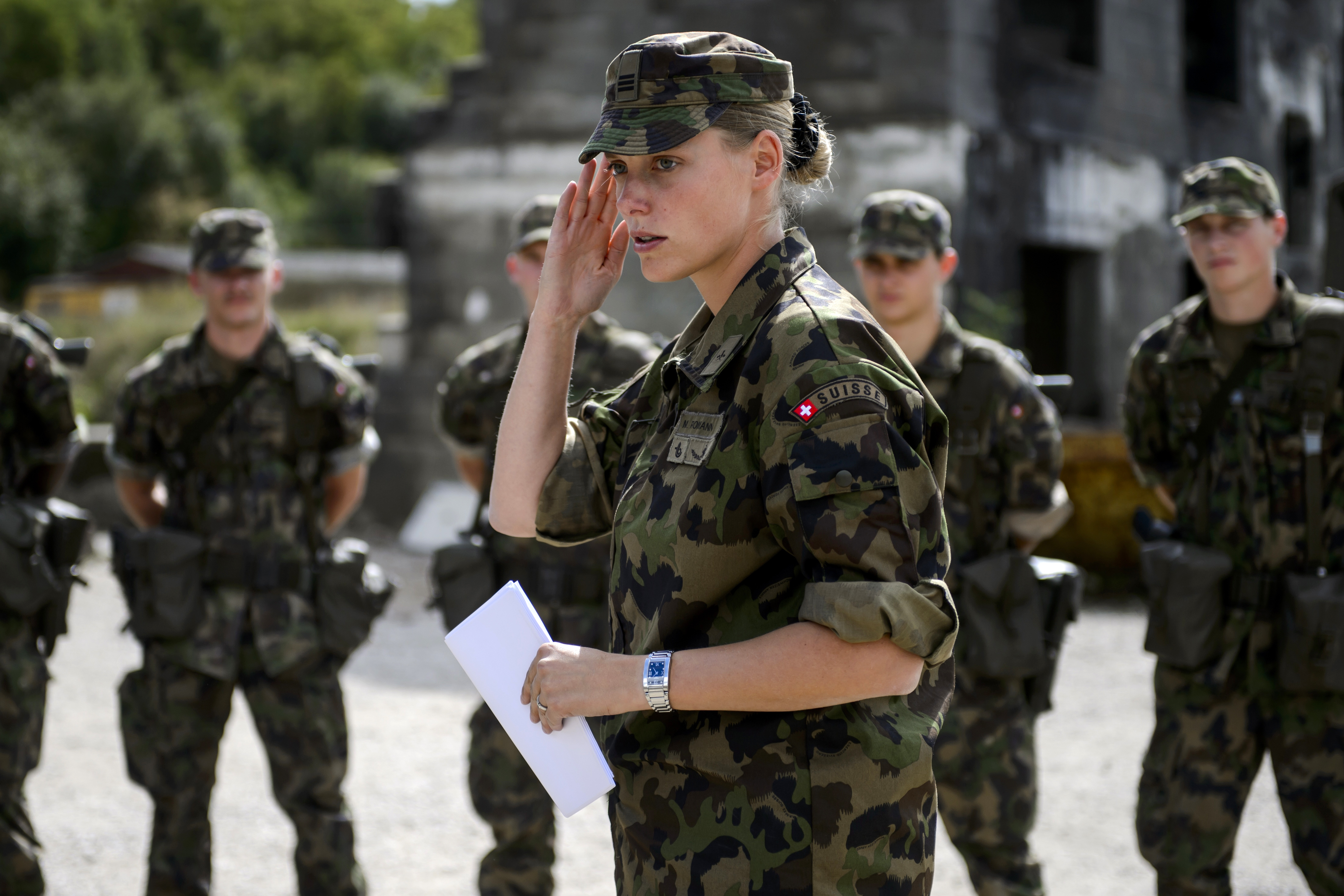 A captain of the rescue troops of the Swiss Army salutes next to aspirant-officiers in Epeisse near Geneva photo.