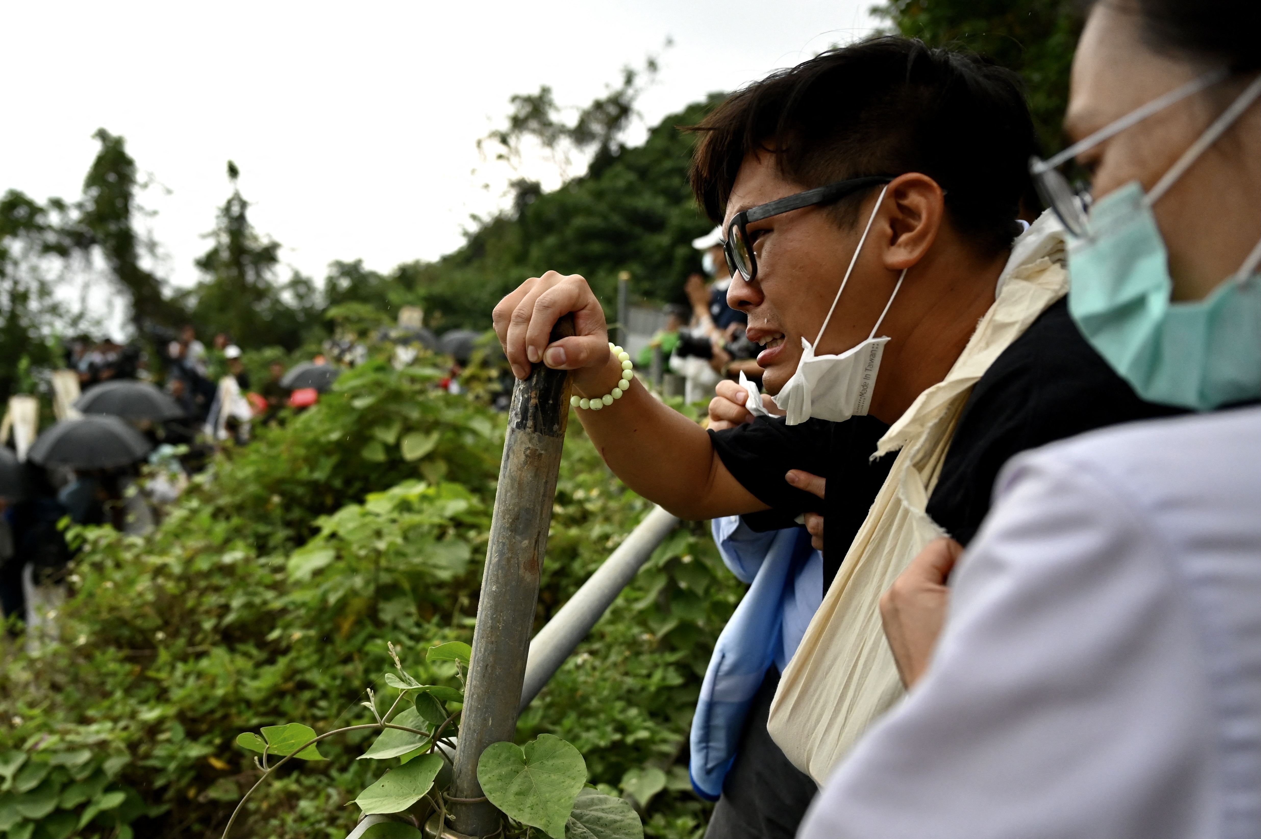 Relatives of the victims who died on the derailed train, pray at the accident site on the mountains of Hualien photo.