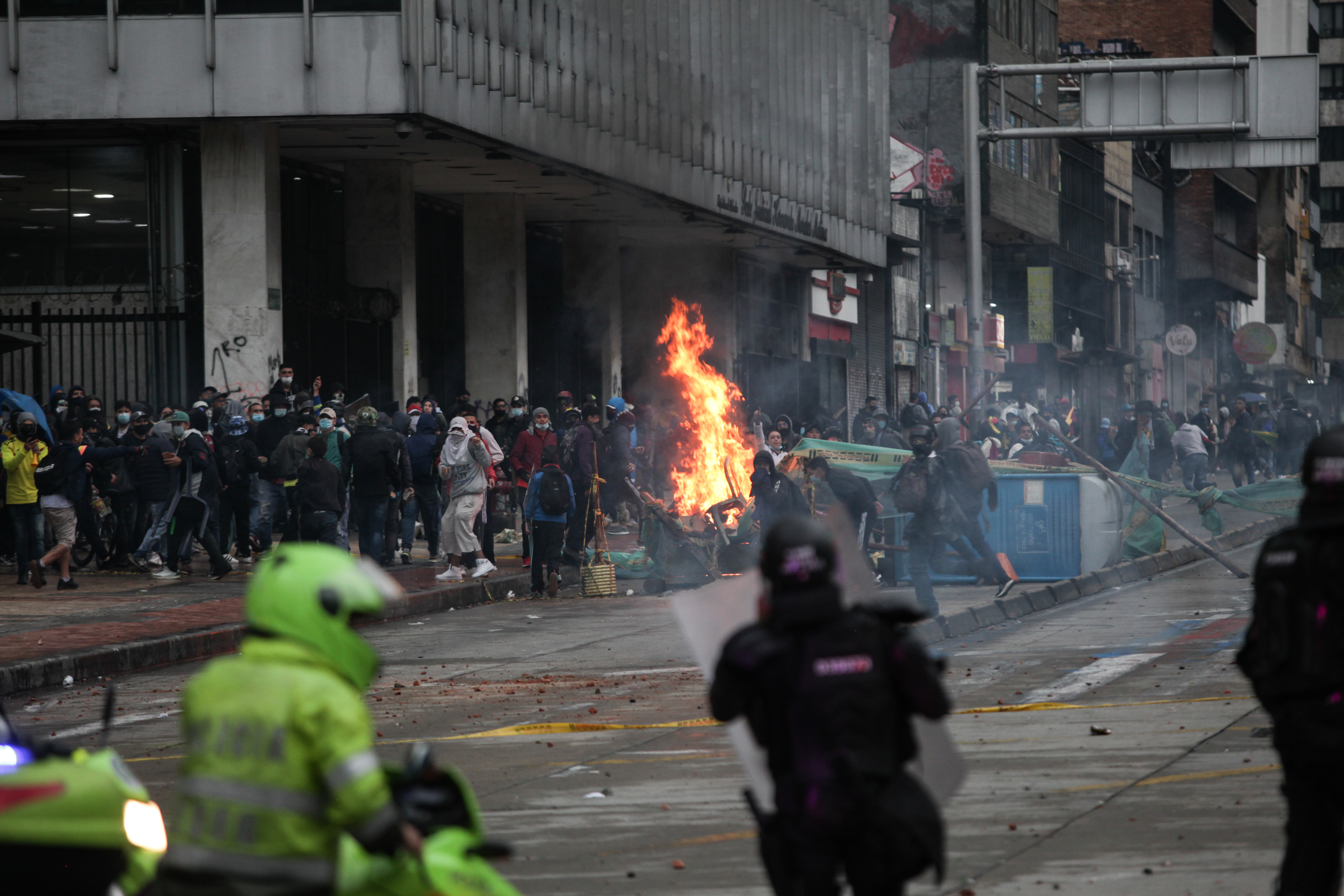 Protesters clash with riot police officers during the International Workers Day against the tax reform proposed by President of Colombia Duque's administration in Bogota, Colombia.