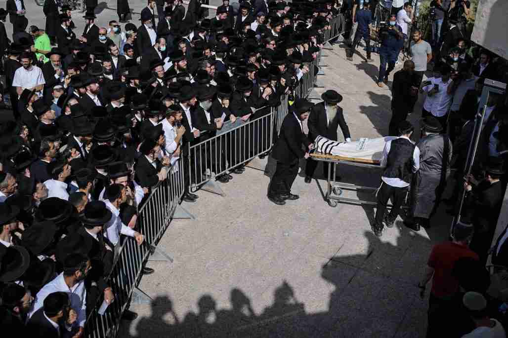 Mourners gather during the funeral of one of those who died in a stampede during the Jewish religious festival of Lag Ba'Omer at the Jewish Orthodox pilgrimage site of Mount Meron.