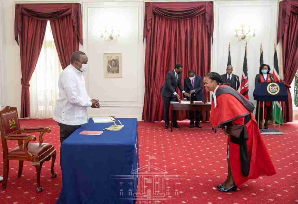 Martha Koome bows to Kenya's president Uhuru Kenyatta