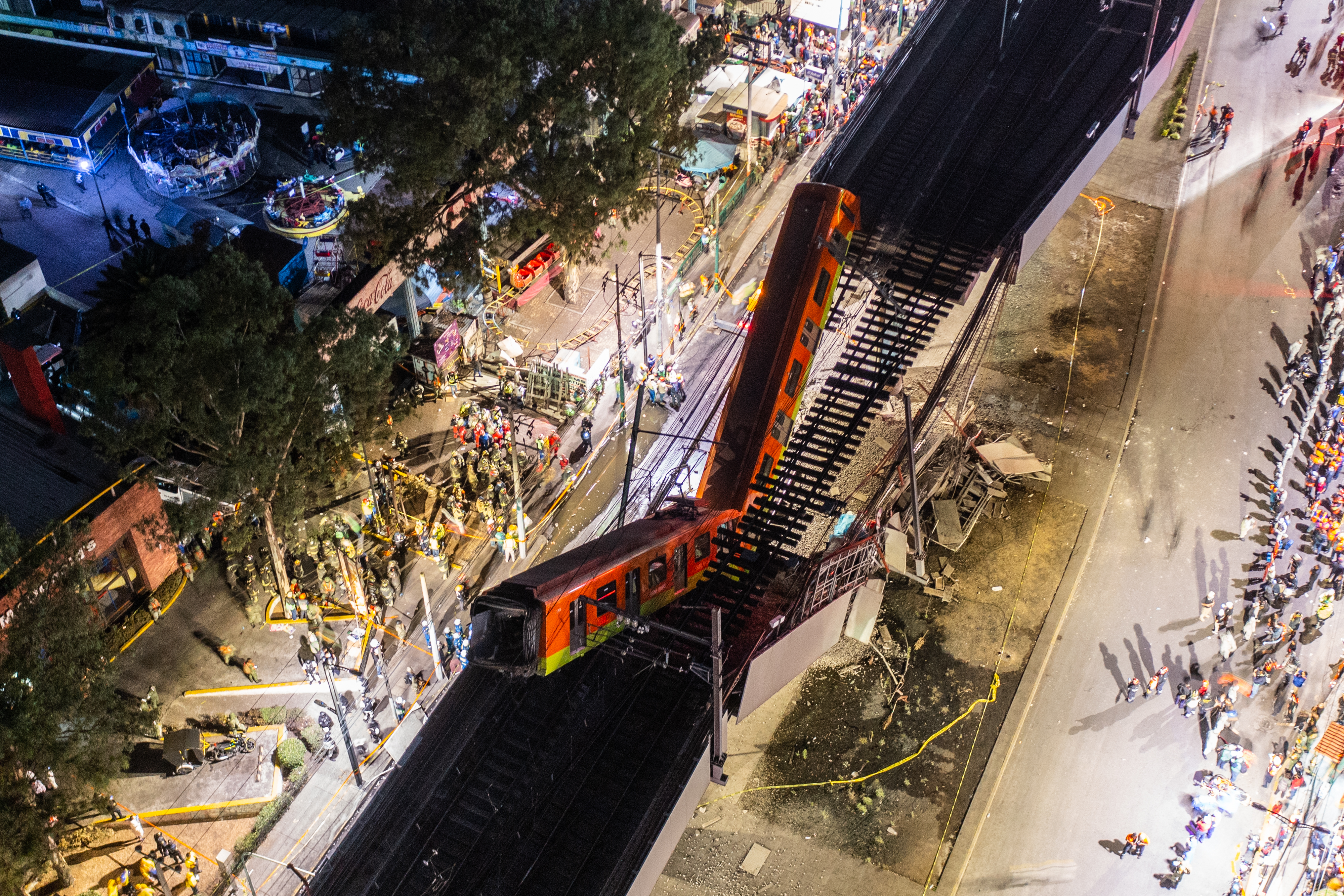 An aerial view of the scene after an elevated section of metro track in Mexico City, carrying train cars with passengers, collapsed onto a busy road in Mexico City, Mexico.