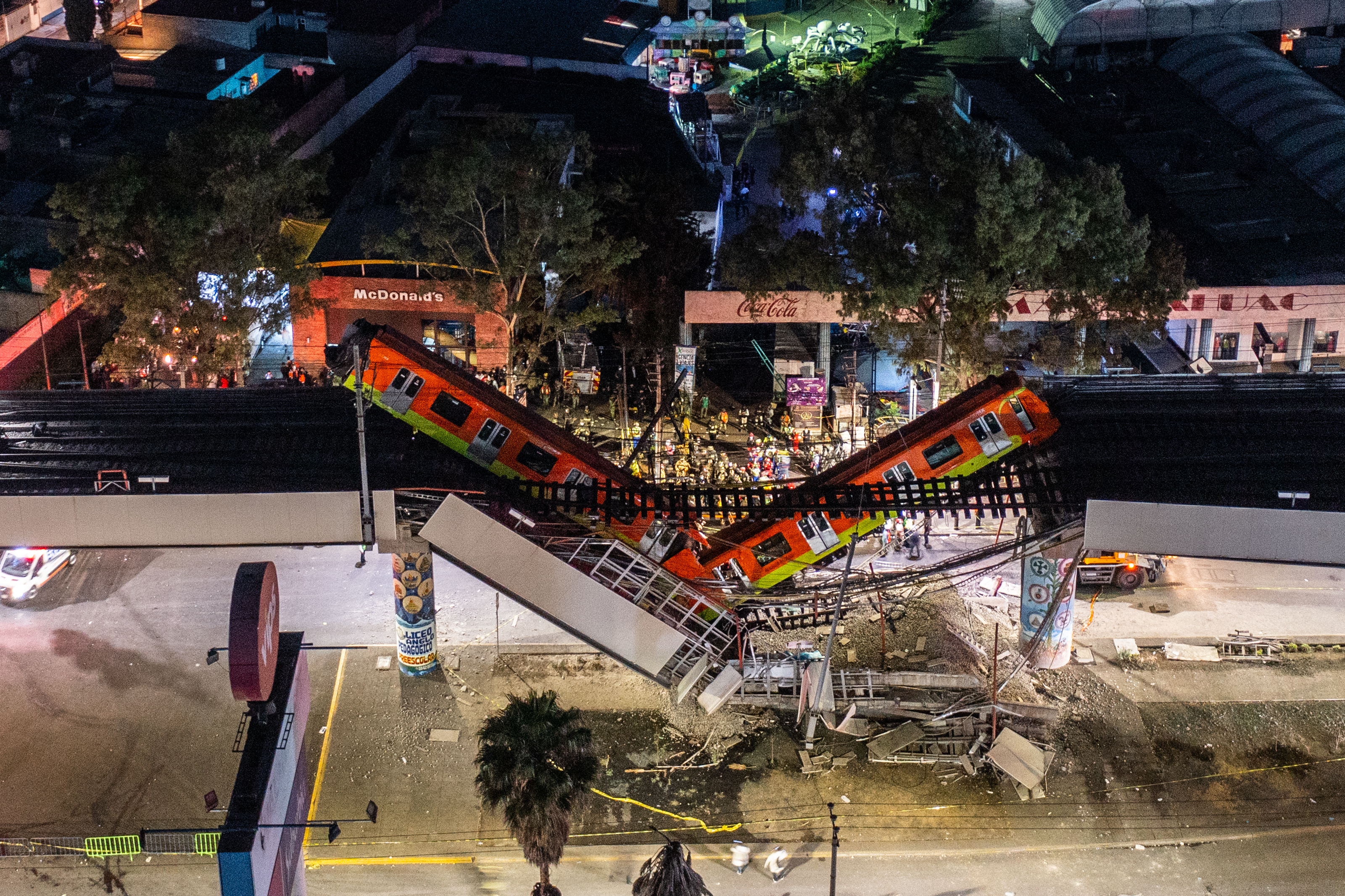 An aerial view of the scene after an elevated section of metro track in Mexico City, carrying train cars with passengers, collapsed onto a busy road in Mexico City, Mexico.