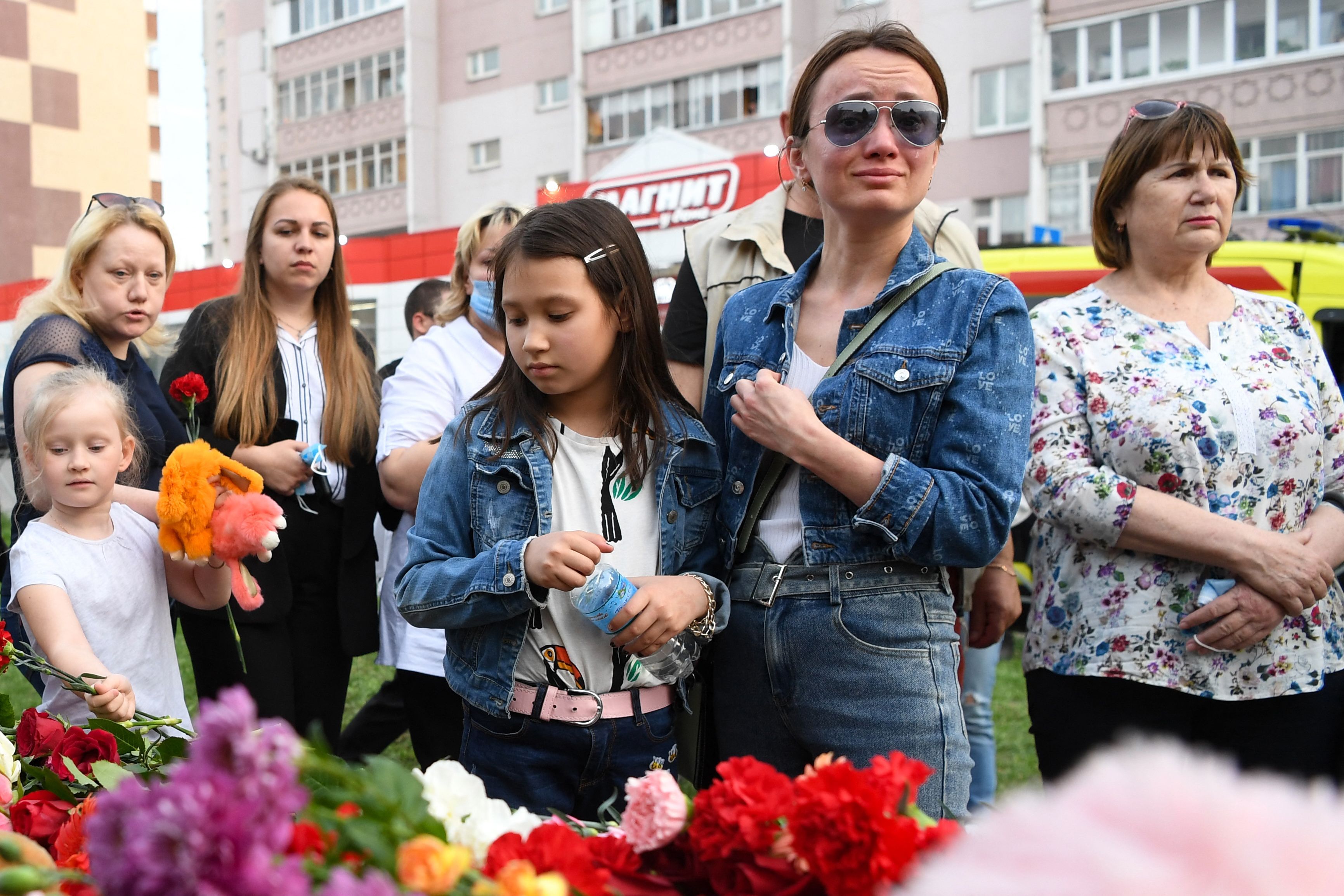A woman cries at a makeshift memorial for victims of the shooting at School No. 175 in Kazan.