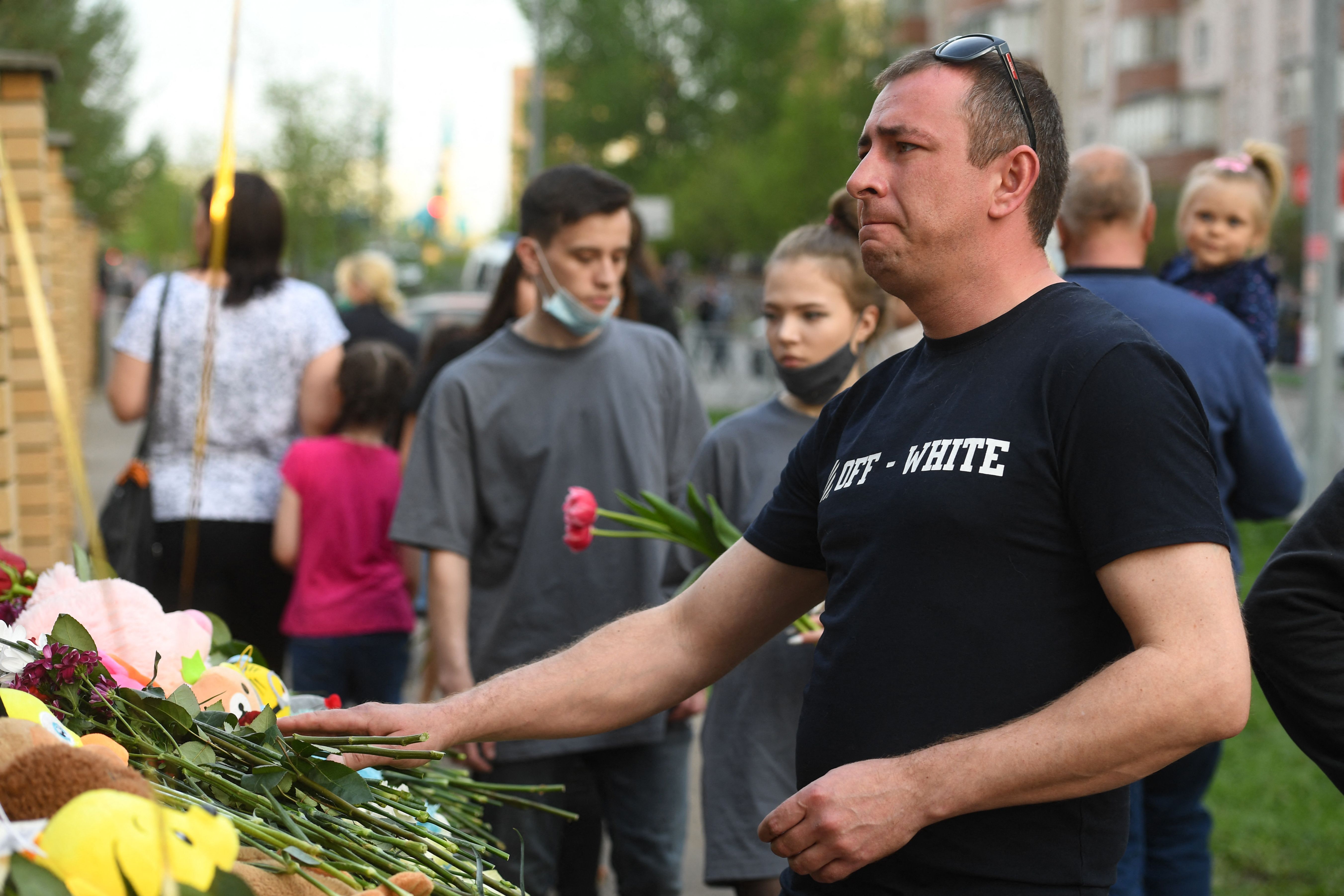 People lay flowers at a makeshift memorial for victims of the shooting at School No. 175 in Kazan.