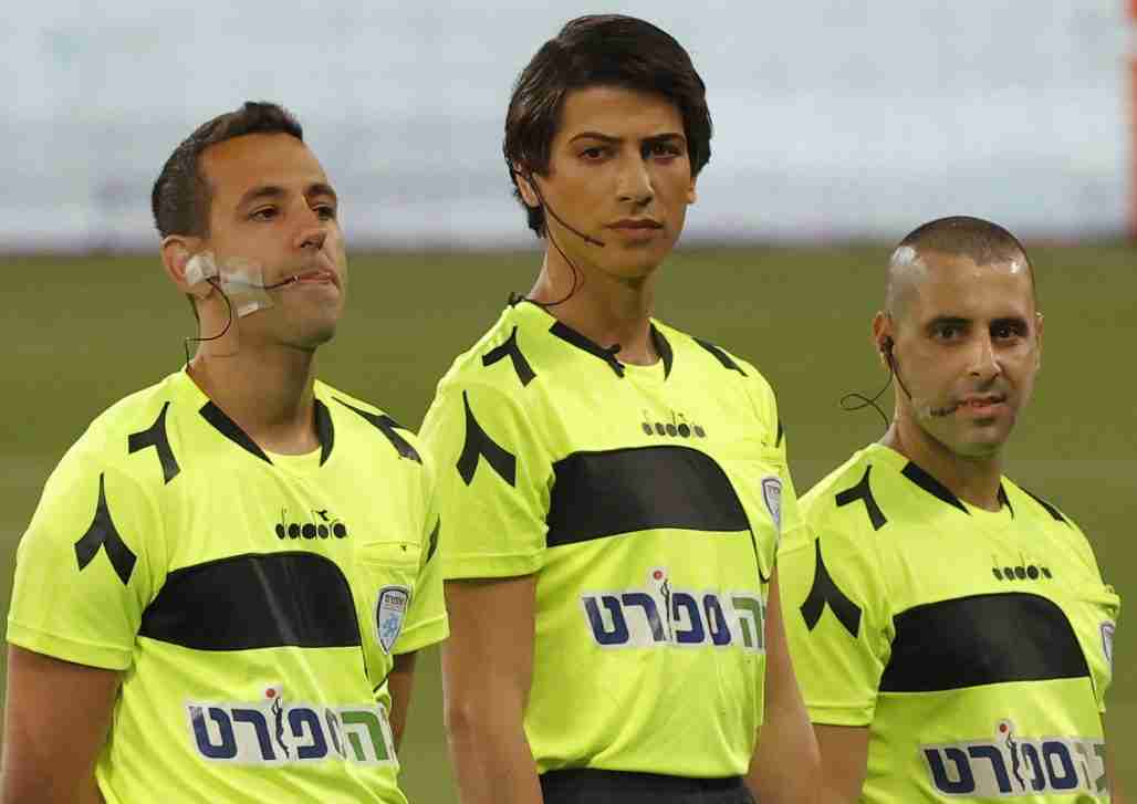 Israeli football referee Sapir Berman (C) stands with other match officials and players on the pitch before the start of the Israeli Premier League match between Hapoel Haifa and Beitar Jerusalem at Samy Ofer Stadium in Israel's northern Mediterranean coastal city of Haifa.
