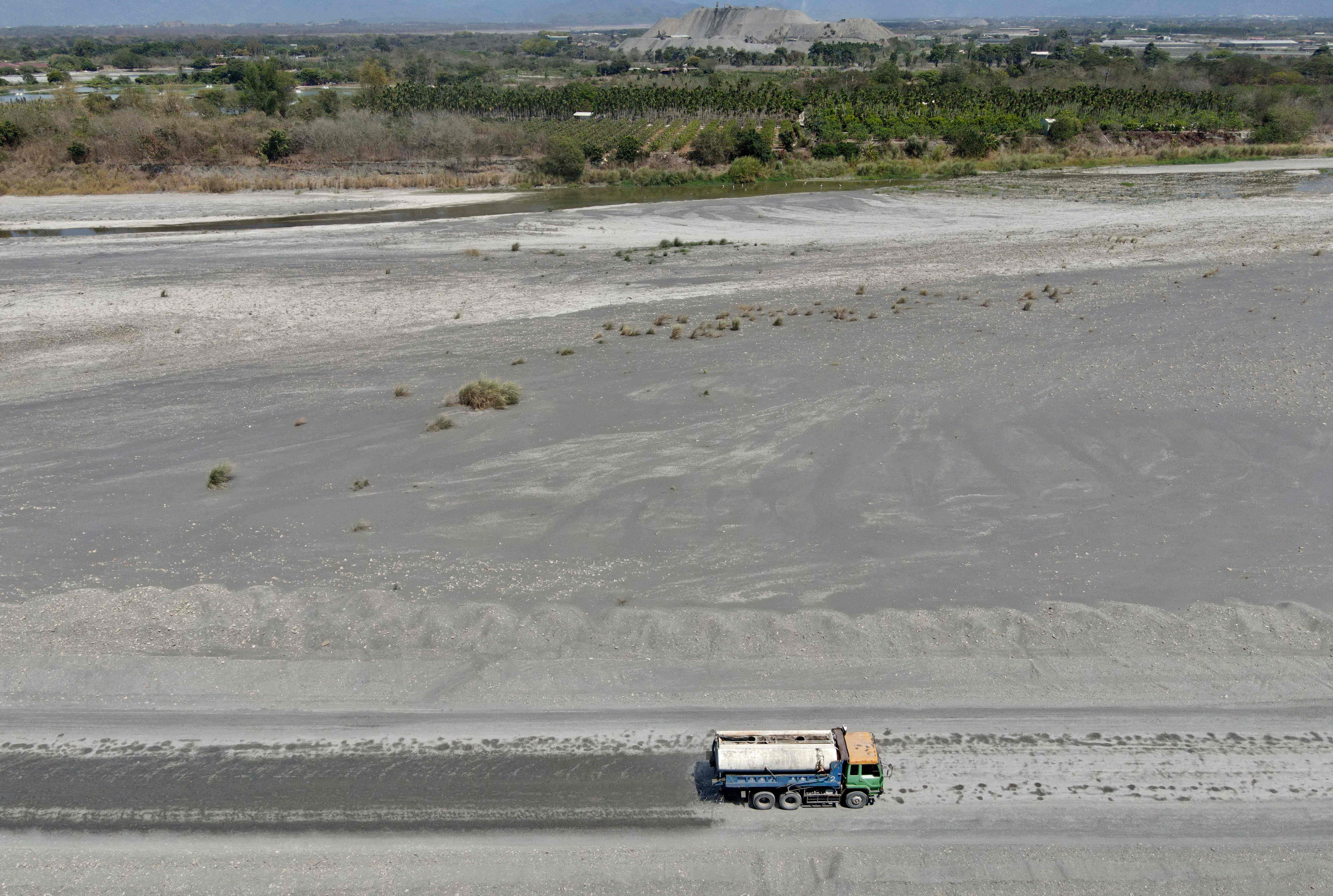 This aerial photo shows a truck riding along the empty Ai Liao river bed in Pingtung county, southern Taiwan.