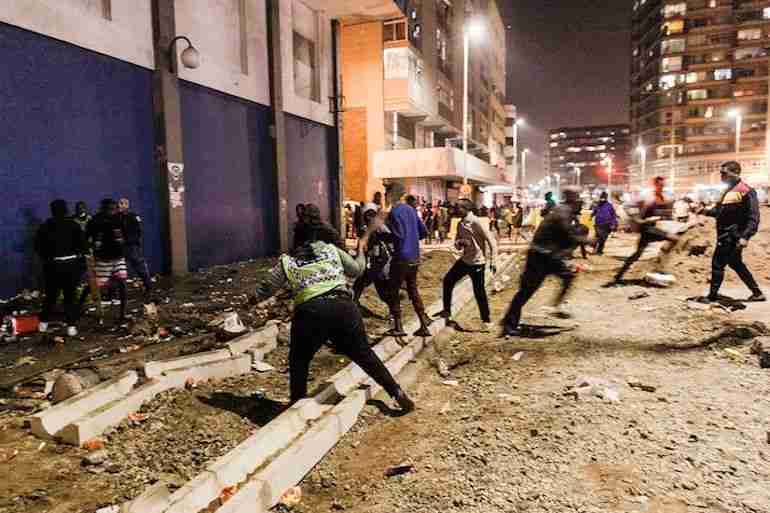 South Africa Police Services (SAPS) officers try to cease looting in central Durban.