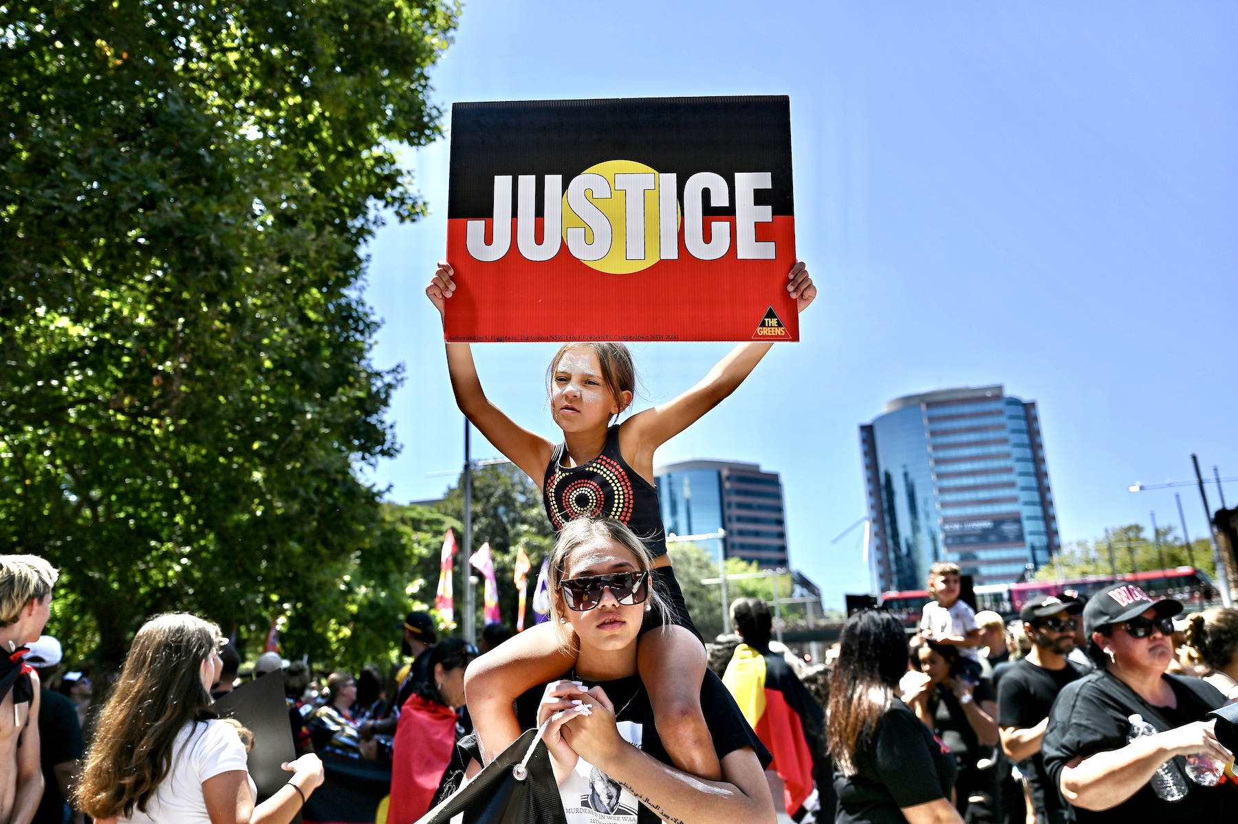 girl with justice sign australia invasion day protest 2023