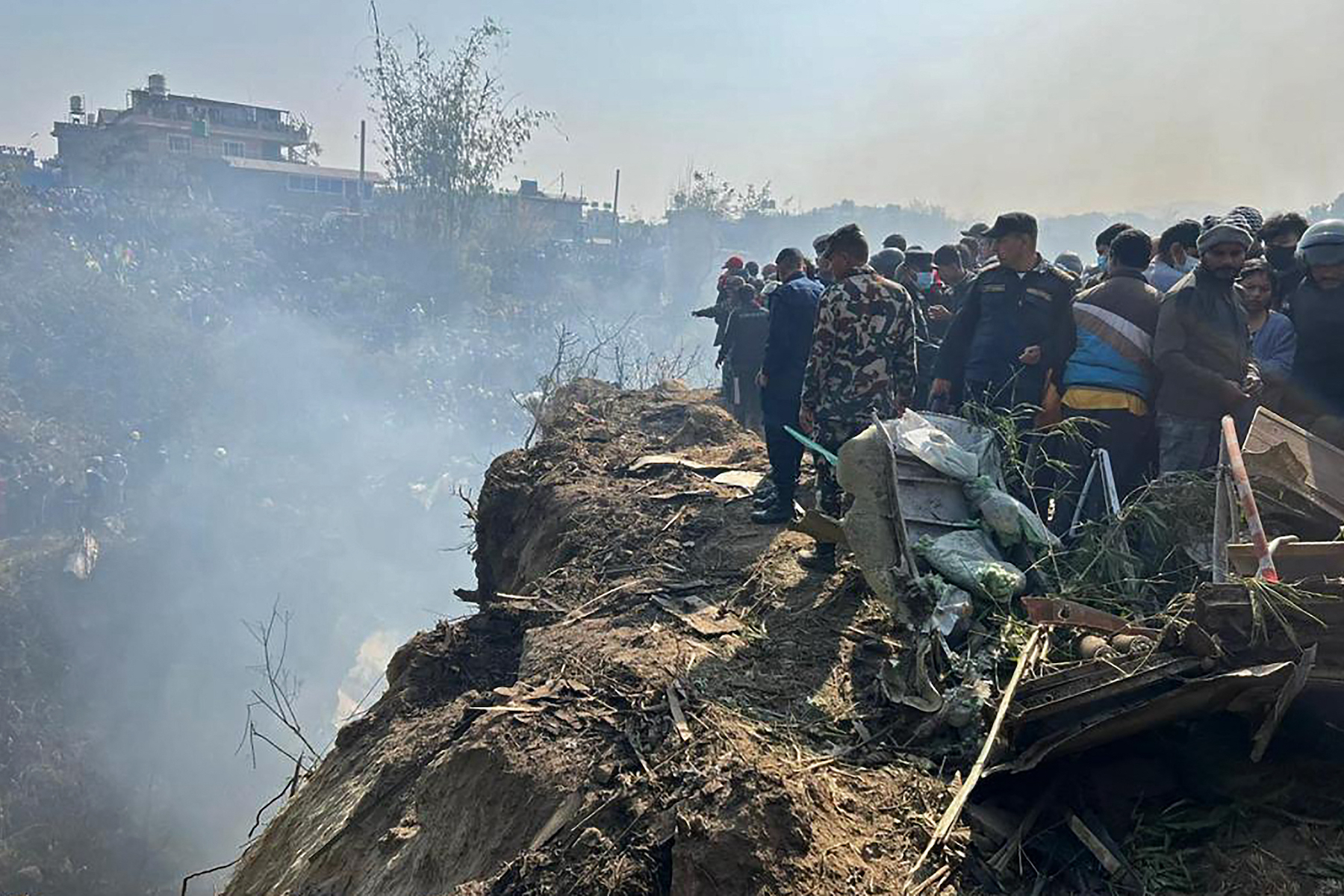 nepal plane crash site people surrounded 2023 yeti airlines