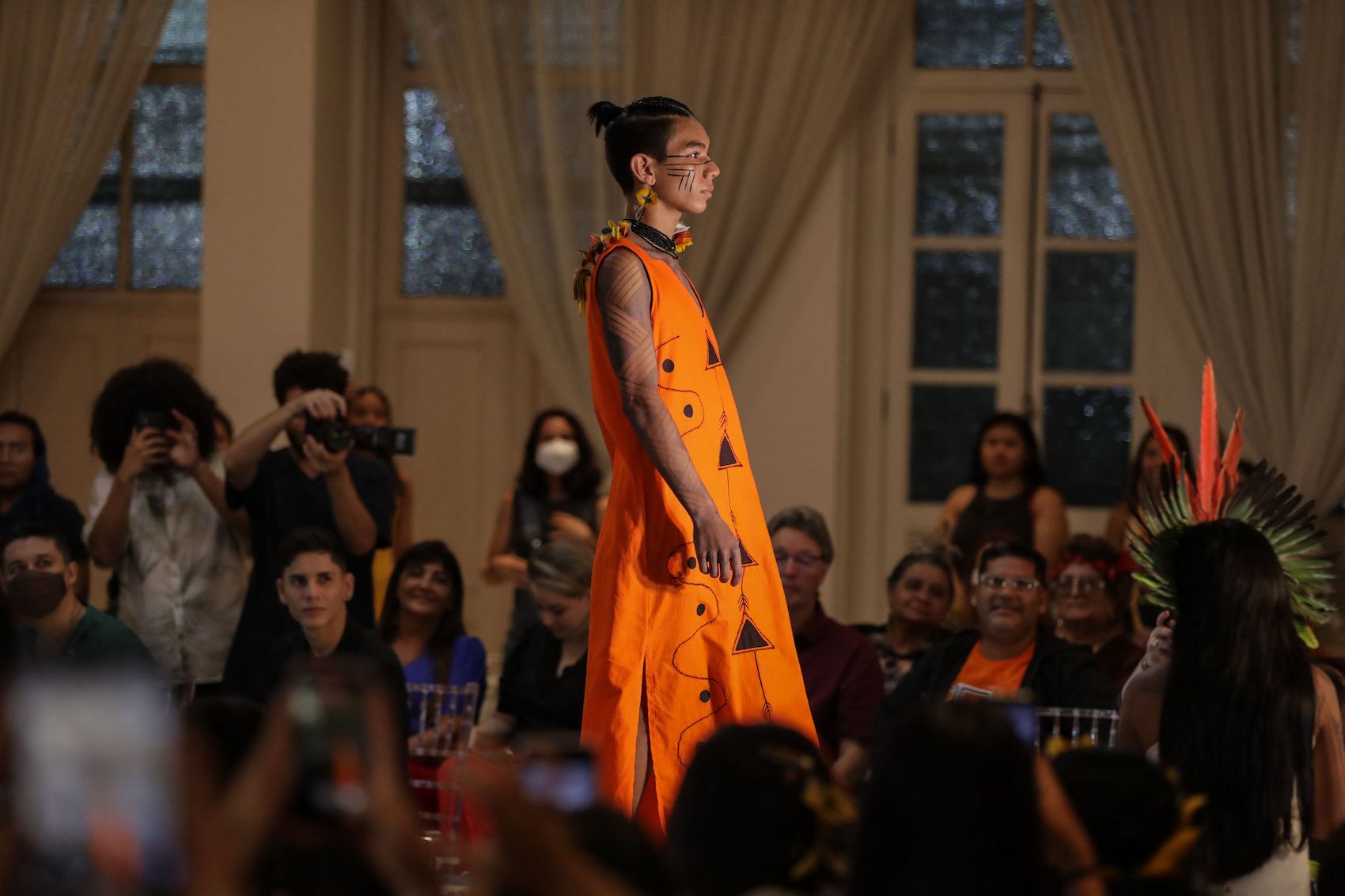 An indigenous model presents a creation on the catwalk of Indigenous fashion show