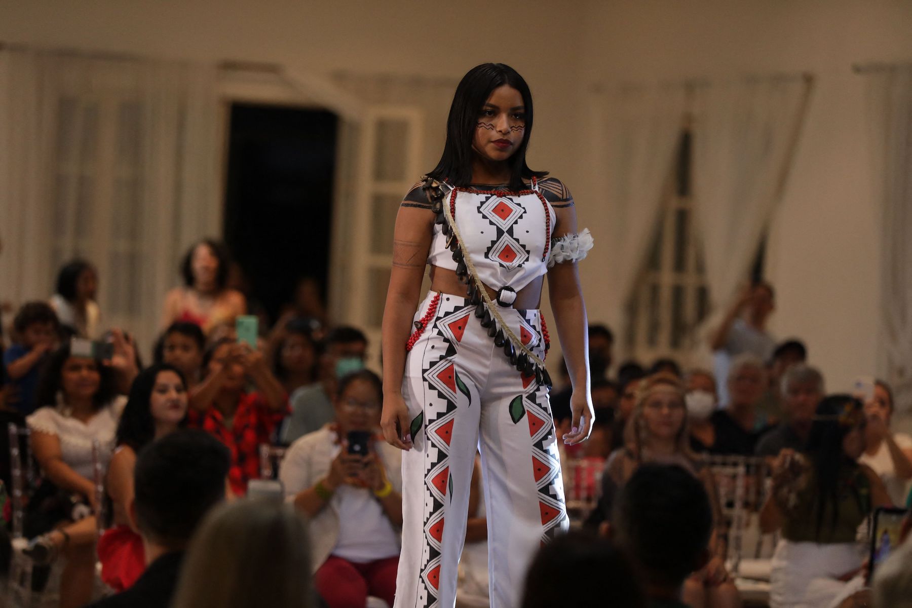A Brazil's Indigenous model walking the catwalk to show off their unique design