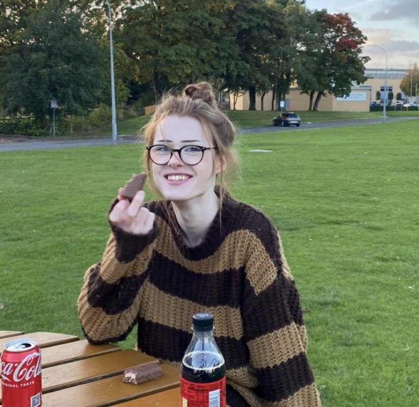 brianna ghey smiling in the picture, eating snacks and sitting on a park bench - who has found murdered in a park in uk