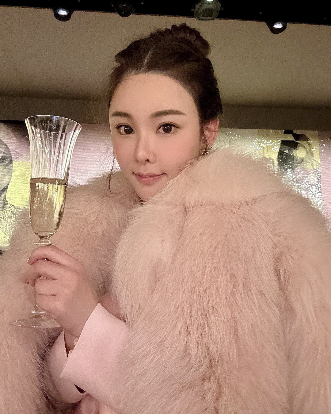 Abby Choi, a Hong Kong influencer holding a champagne glass