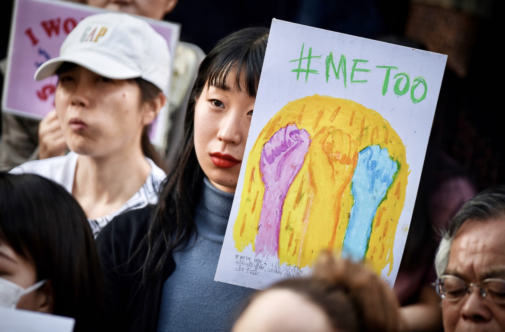 A demonstrator holds a sign reading "#Me Too" during a rally against sexual harassment in Shinjuku, Tokyo