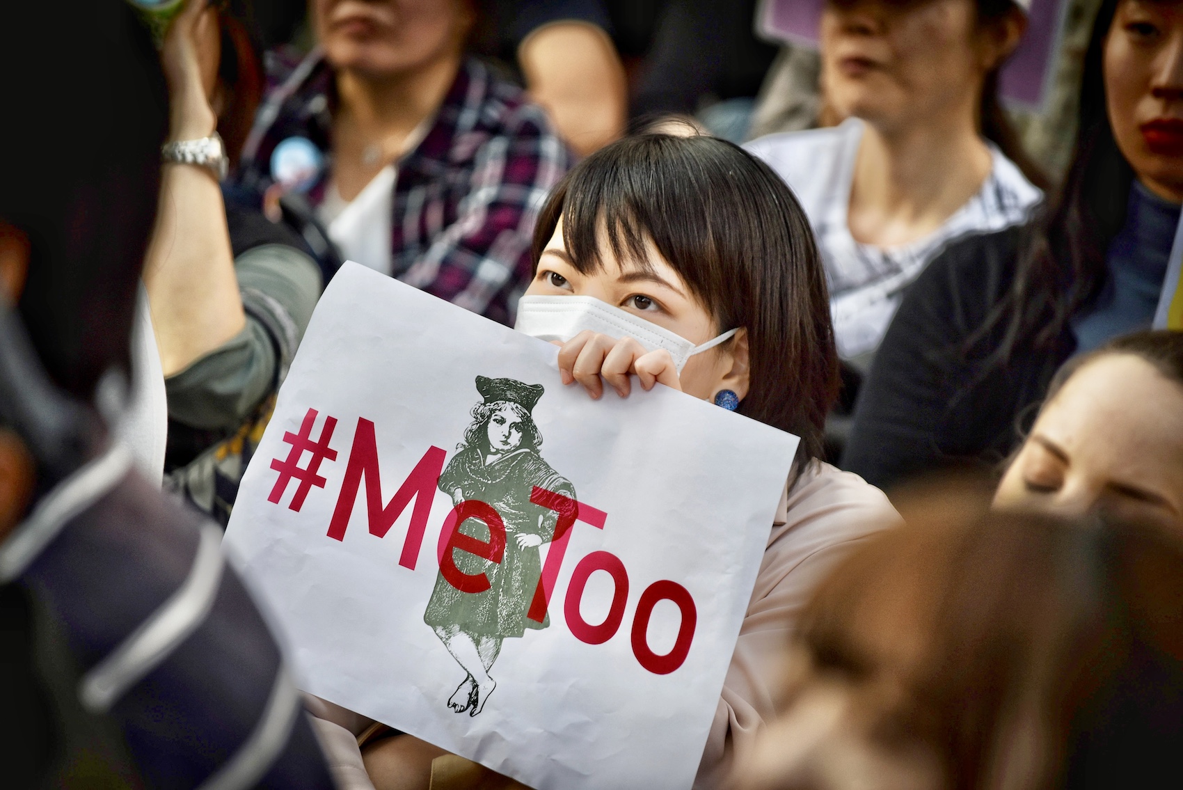 A demonstrator holds a sign reading "#Me Too" during a rally against sexual harassment in Shinjuku, Tokyo