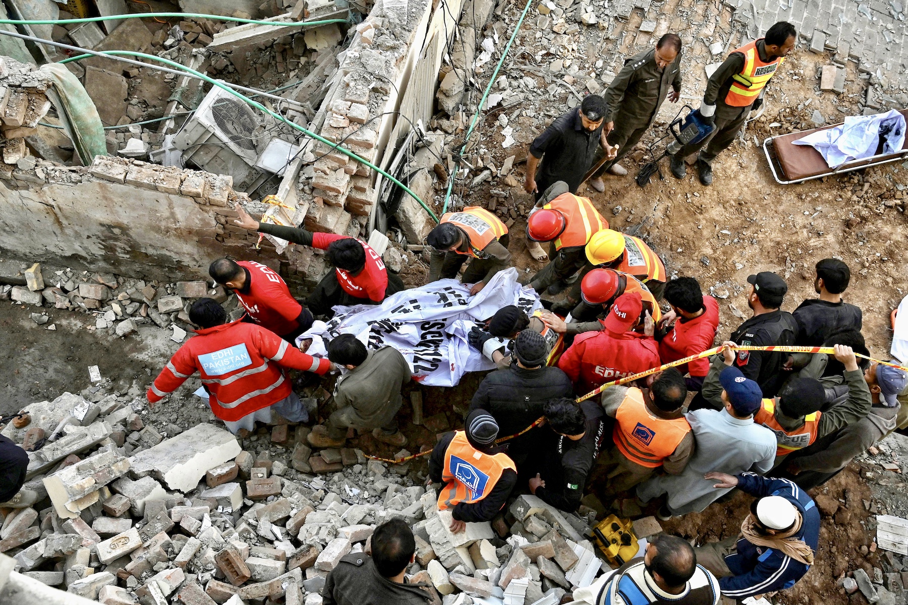 rescuers are carrying bodies out from the site being attacked