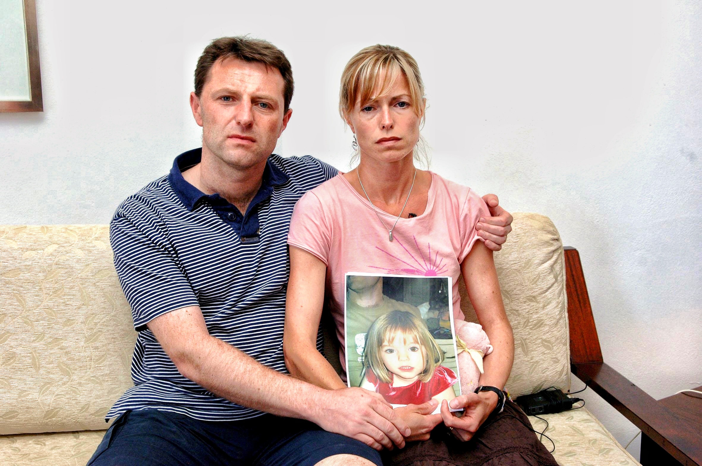 Kate and Gerry McCann holding a picture of their missing child Madeleine McCann