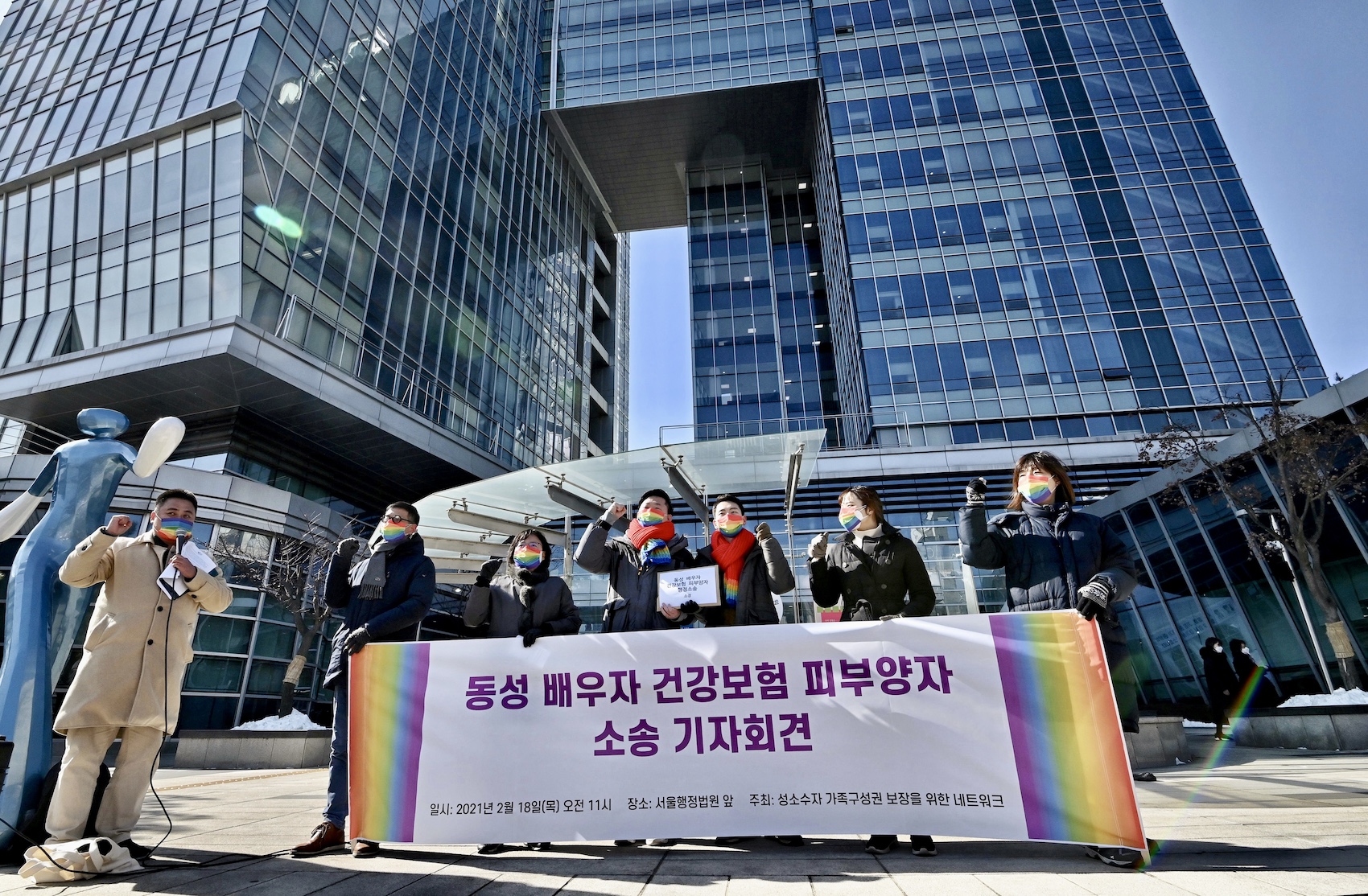 South Korean same-sex couple So Seong-wook (centre L) and Kim Yong-min (centre R) attend a press conference as they file a lawsuit against the National Health Insurance Service for their dependent family status, at the Seoul Administrative Court in Seoul
