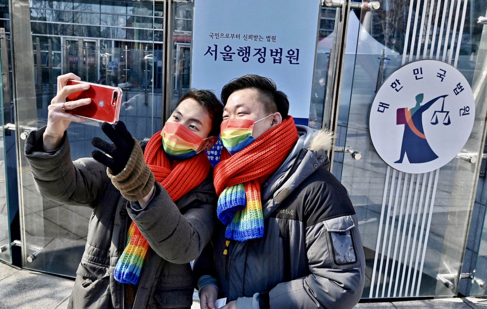 South Korean same-sex couple So Seong-wook (R) and Kim Yong-min (L) take a selfie after a press conference