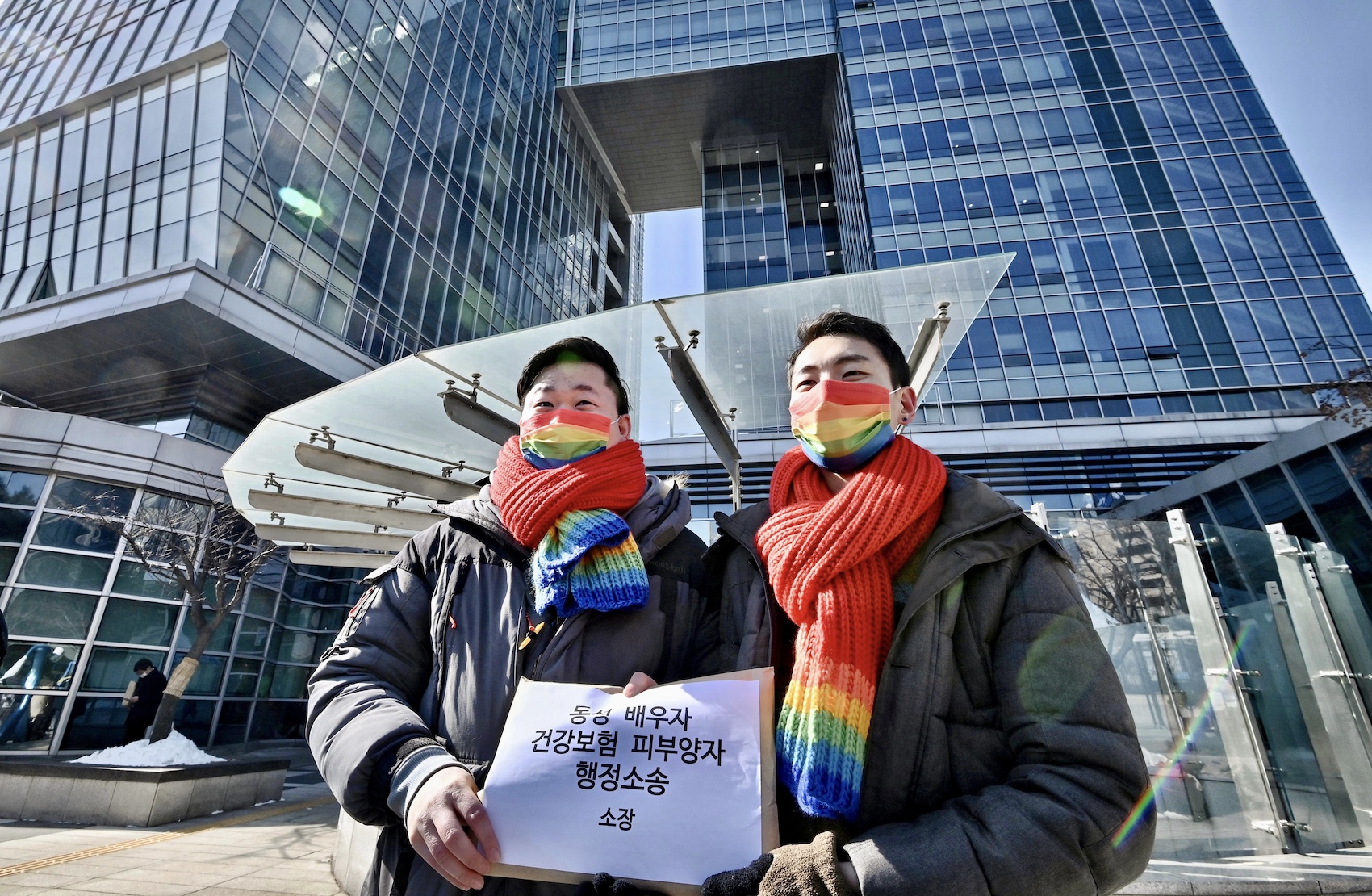 South Korean same-sex couple So Seong-wook (L) and Kim Yong-min (R) attend a press conference as they file a lawsuit against the National Health Insurance Service for their dependent family status
