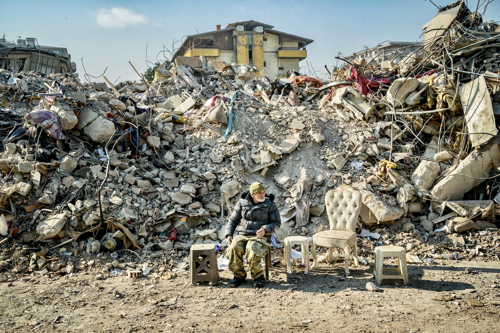 A man guards the ruins of the destroyed buildings in Antakya after the massive earthquake
