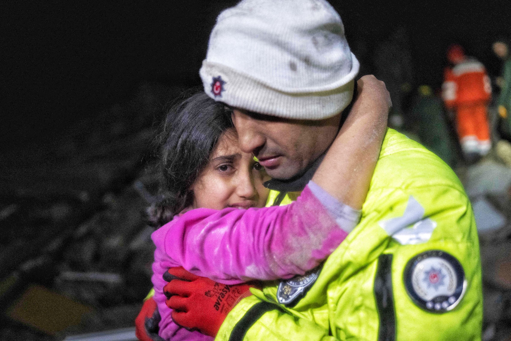 Police officer Zekeriya Yildiz hugs his daughter after they saved her from the rubble in Hatay on February 6, 2023