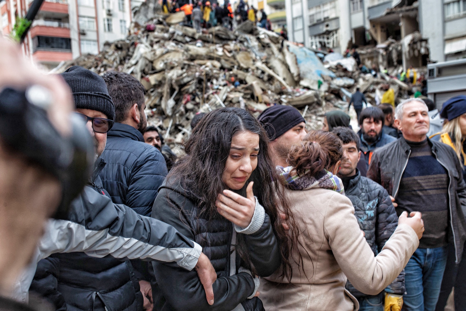 a woman crying at the site struck by the earthquake
