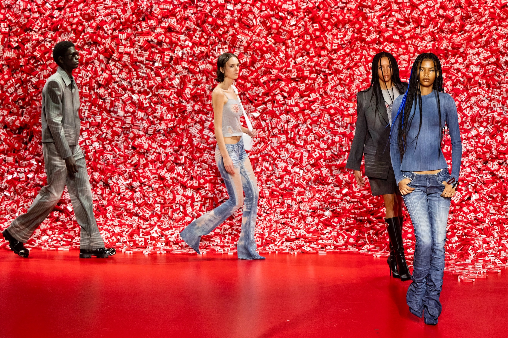 models walking around the condom mountain as the catwalk at milan fashion week 2023