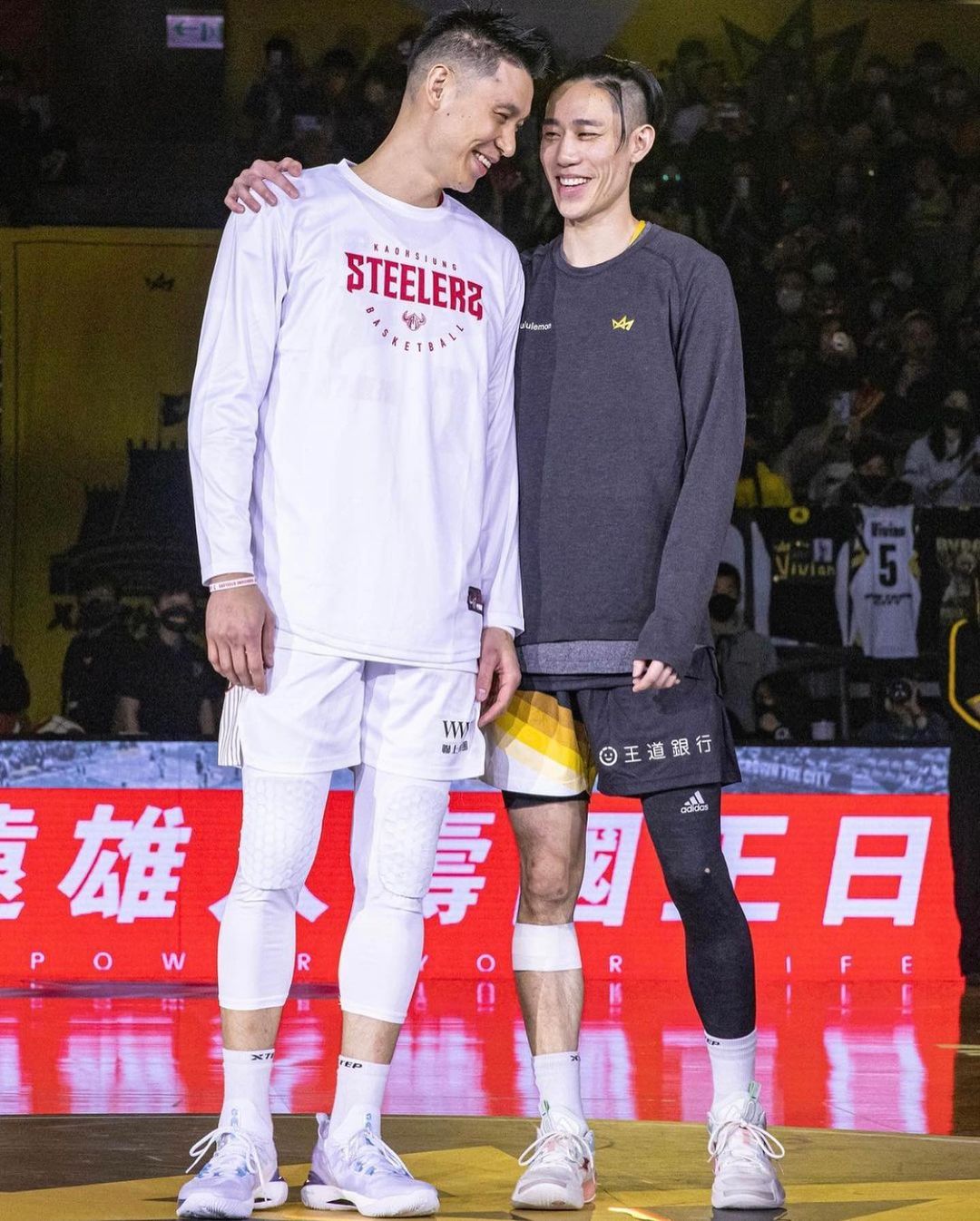 joseph lin holding his brother jeremy lin smiling at the basketball court
