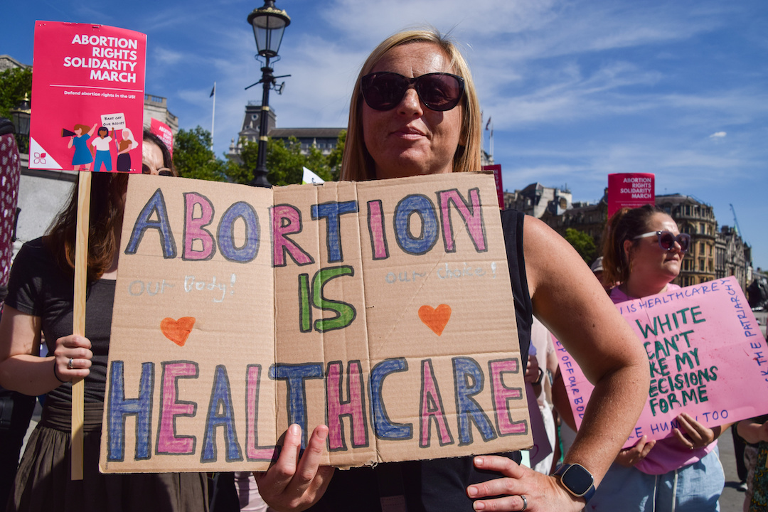 Woman holds "Abortion is healthcare".