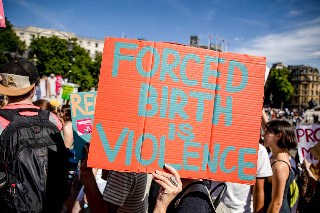 UK abortion protest with sign that says "Forced birth is violence"