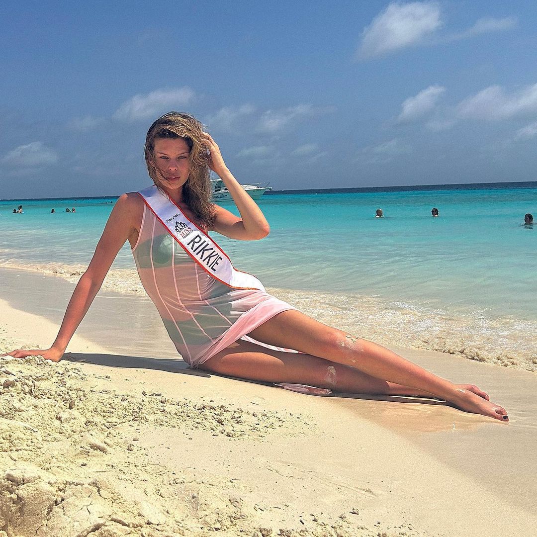 First transgender Miss Netherlands lays on the beach and poses for a picture