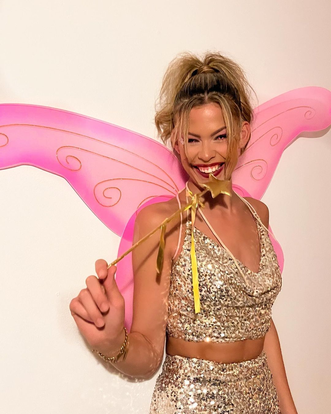 Dutch model and first trans Miss Netherlands poses for a picture wearing a fairy costume and smiling.
