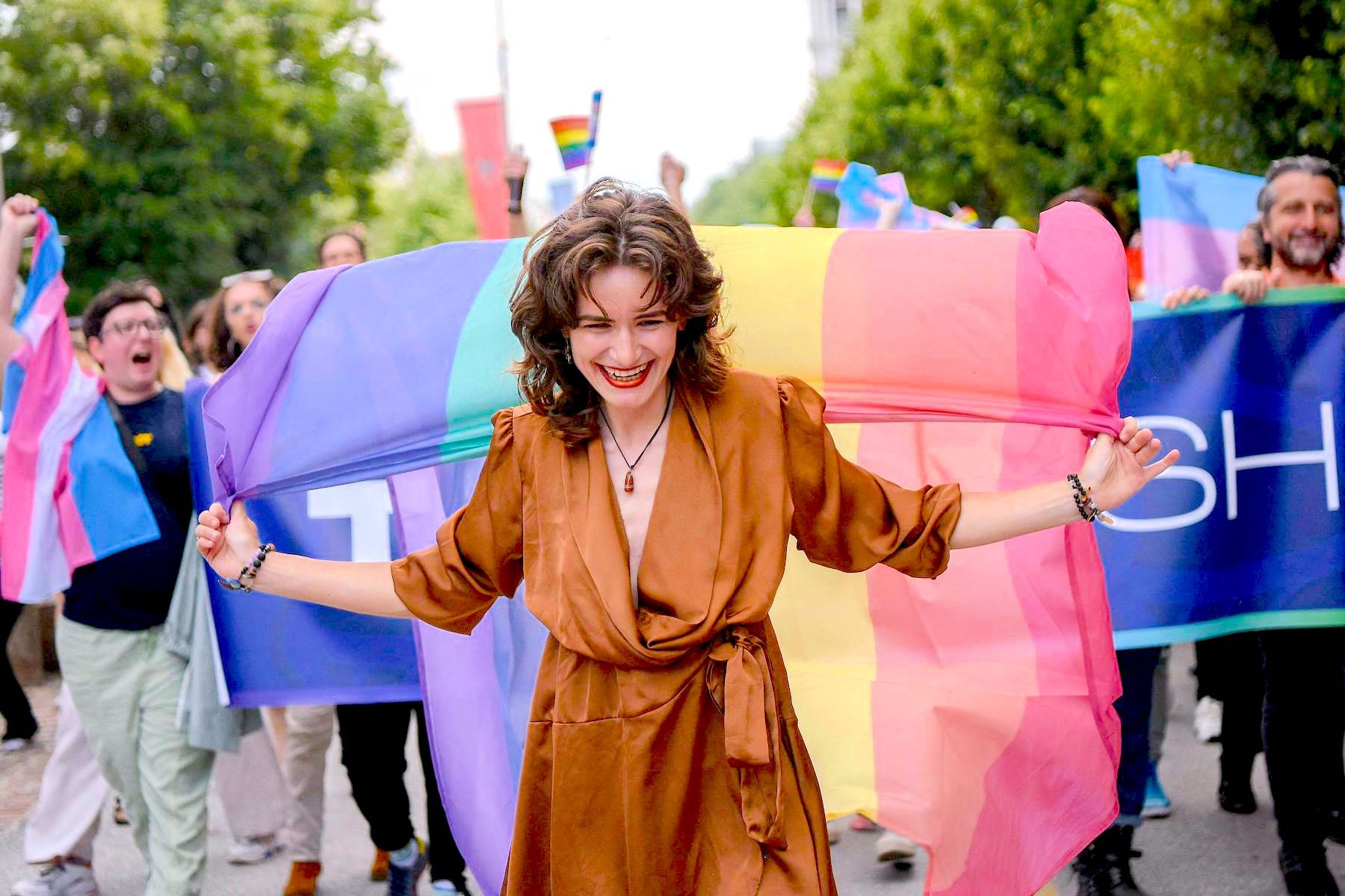 A woman holds an LGBTQ flag during Kosovo's pride march